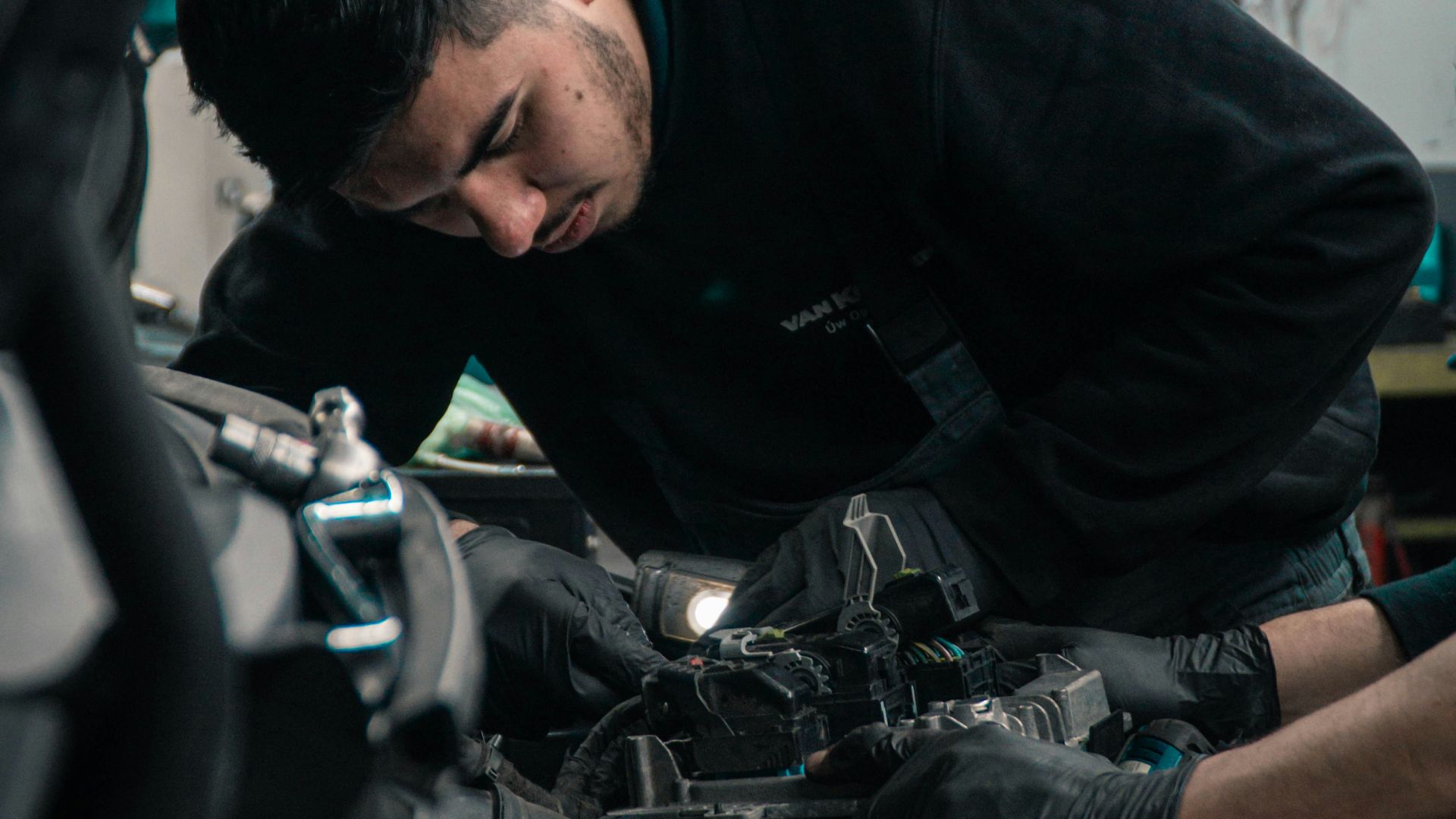 man in black jacket and blue denim jeans riding motorcycle