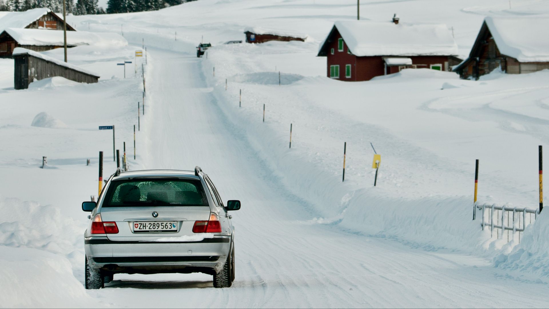 a car driving down a snow covered road