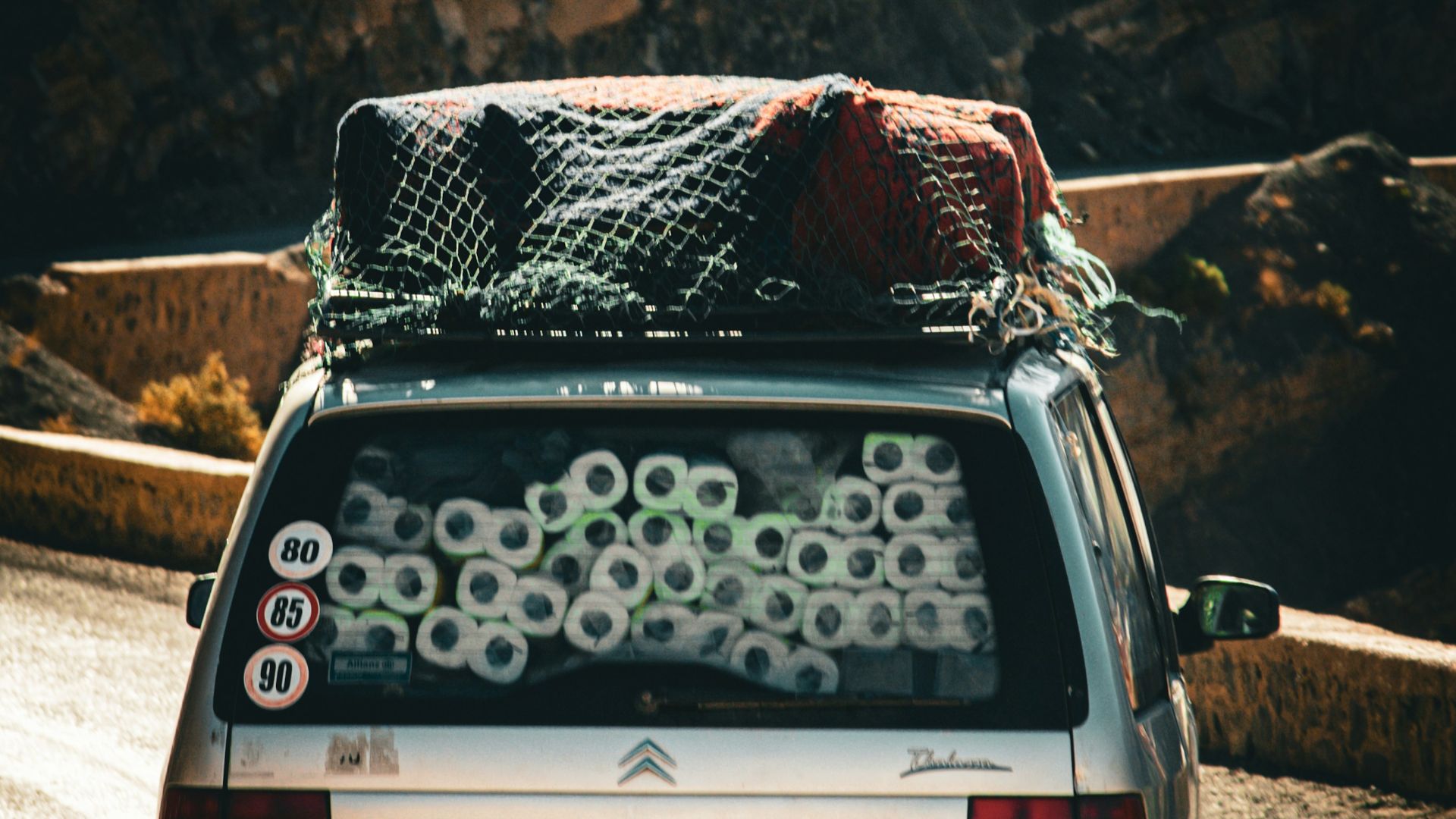 Silver car packed with toilet paper rolls