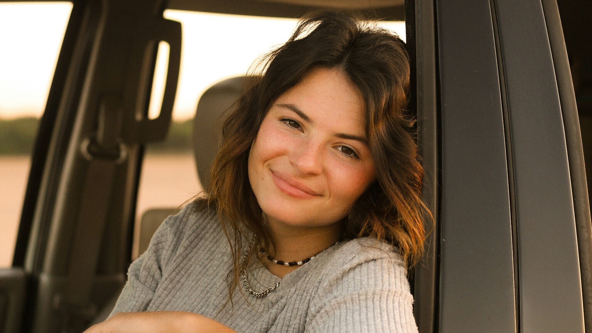 a woman sitting in the drivers seat of a truck