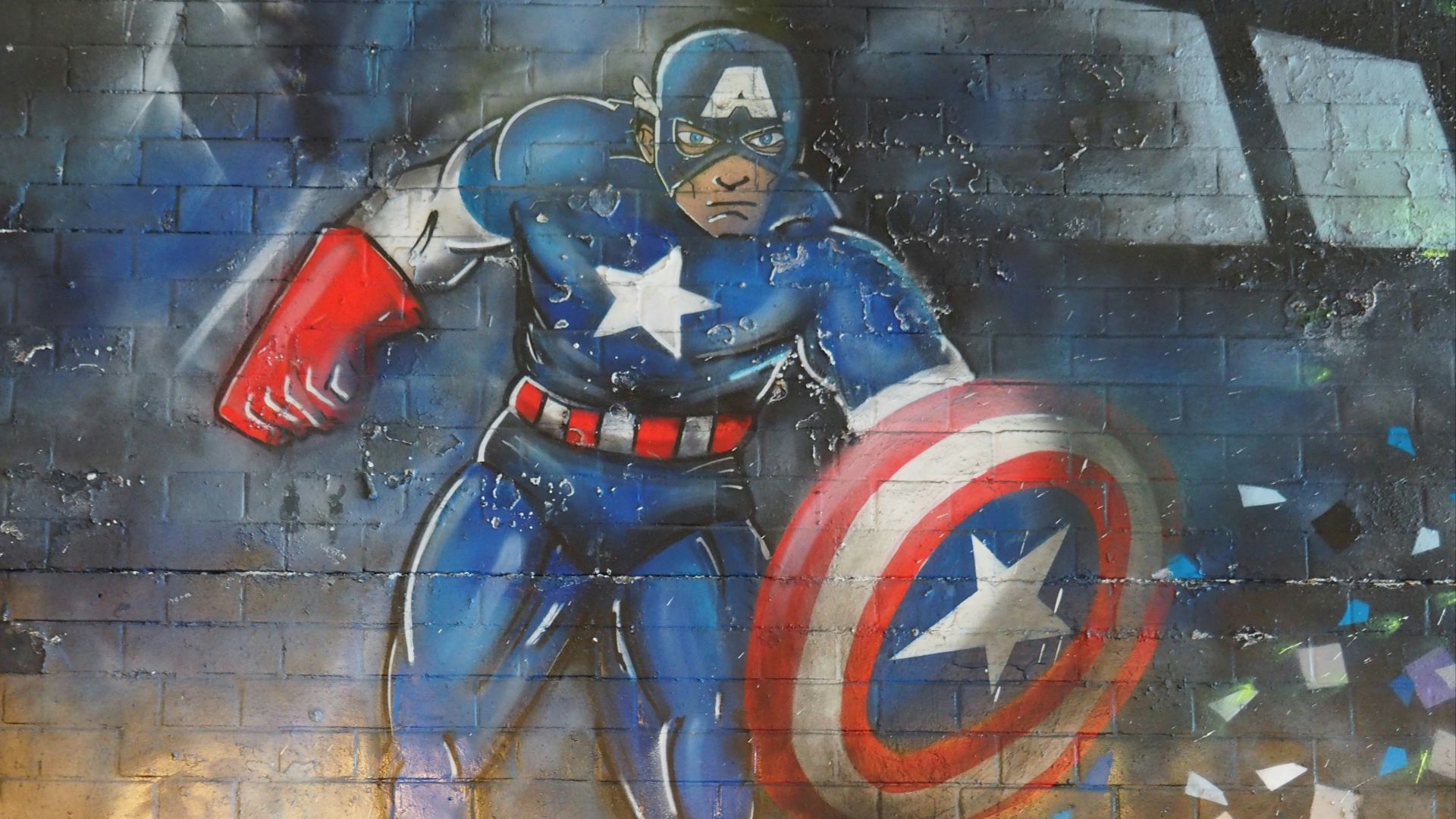 man in blue and red suit holding red and blue shield