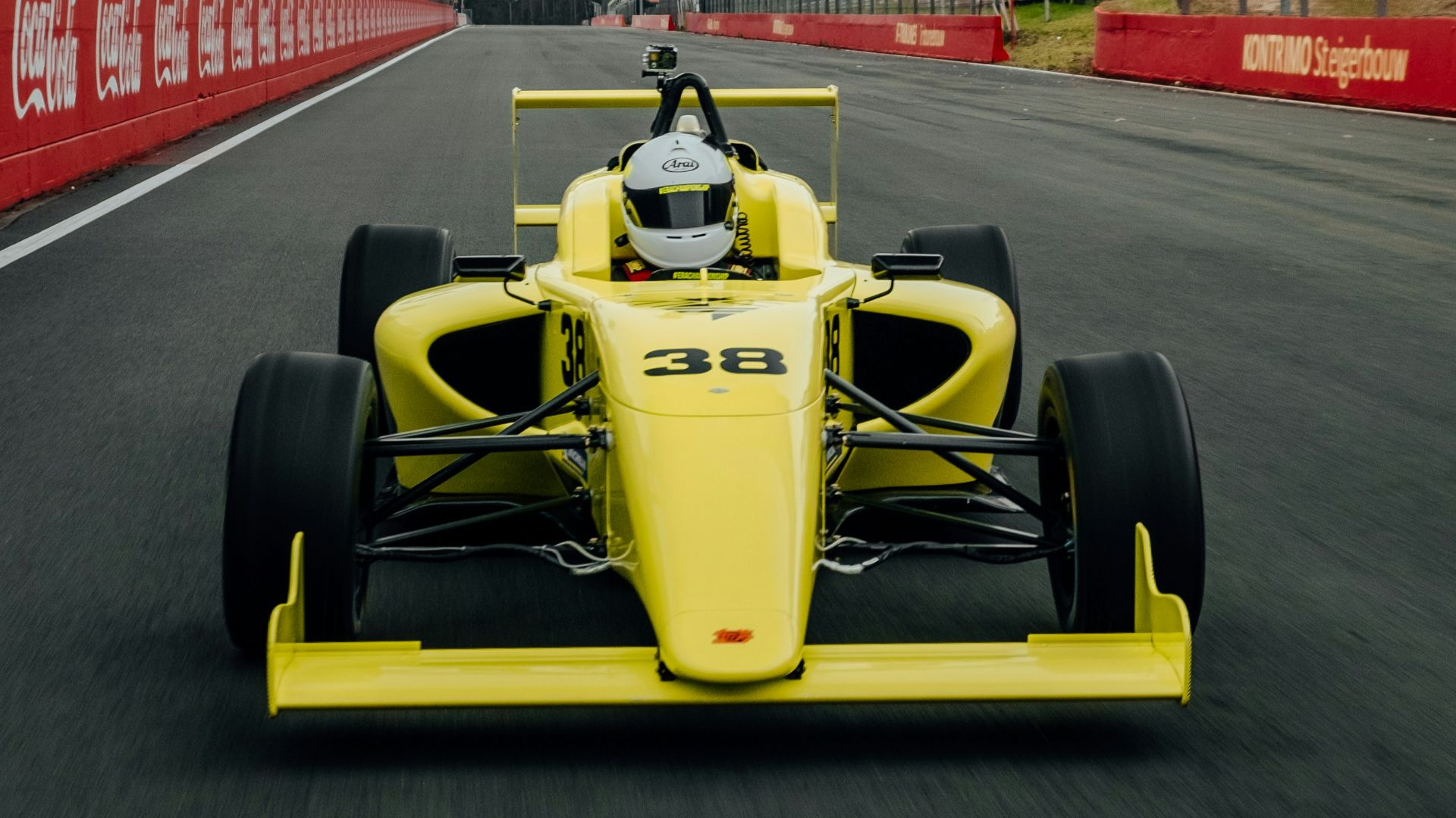 yellow and black f 1 car on road during daytime