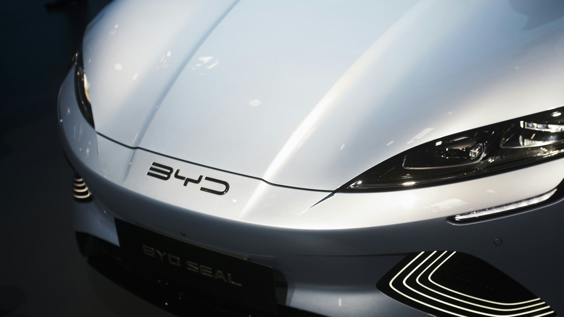 a white sports car is on display at a car show