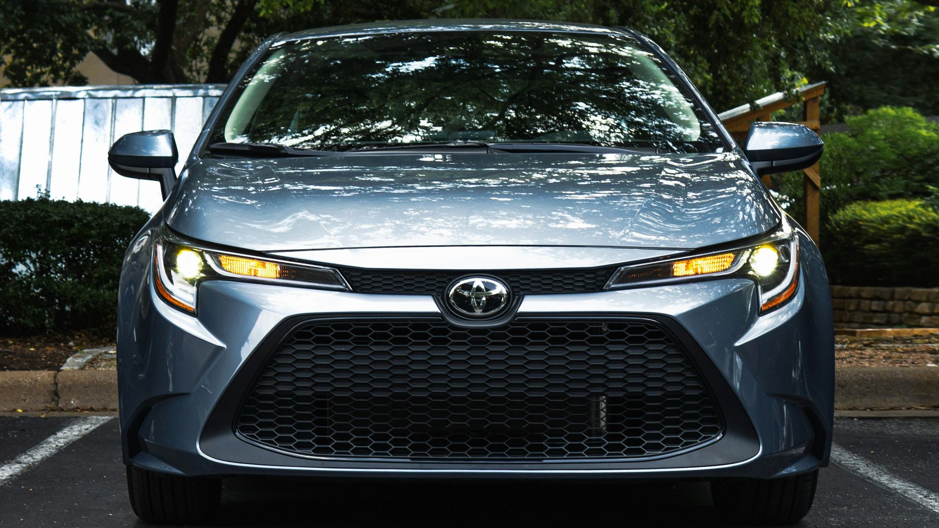 black mercedes benz car parked near green trees during daytime