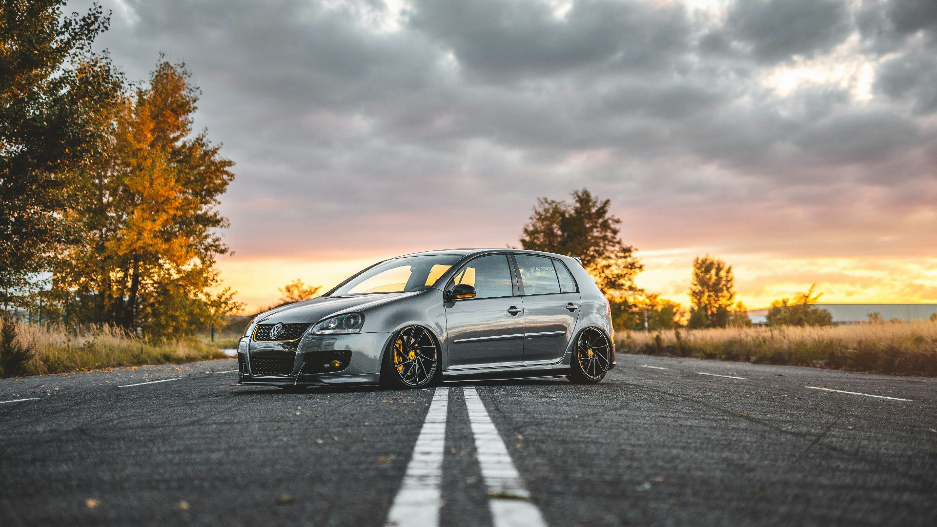 silver 5-door hatchback parked in the middle of the road during day