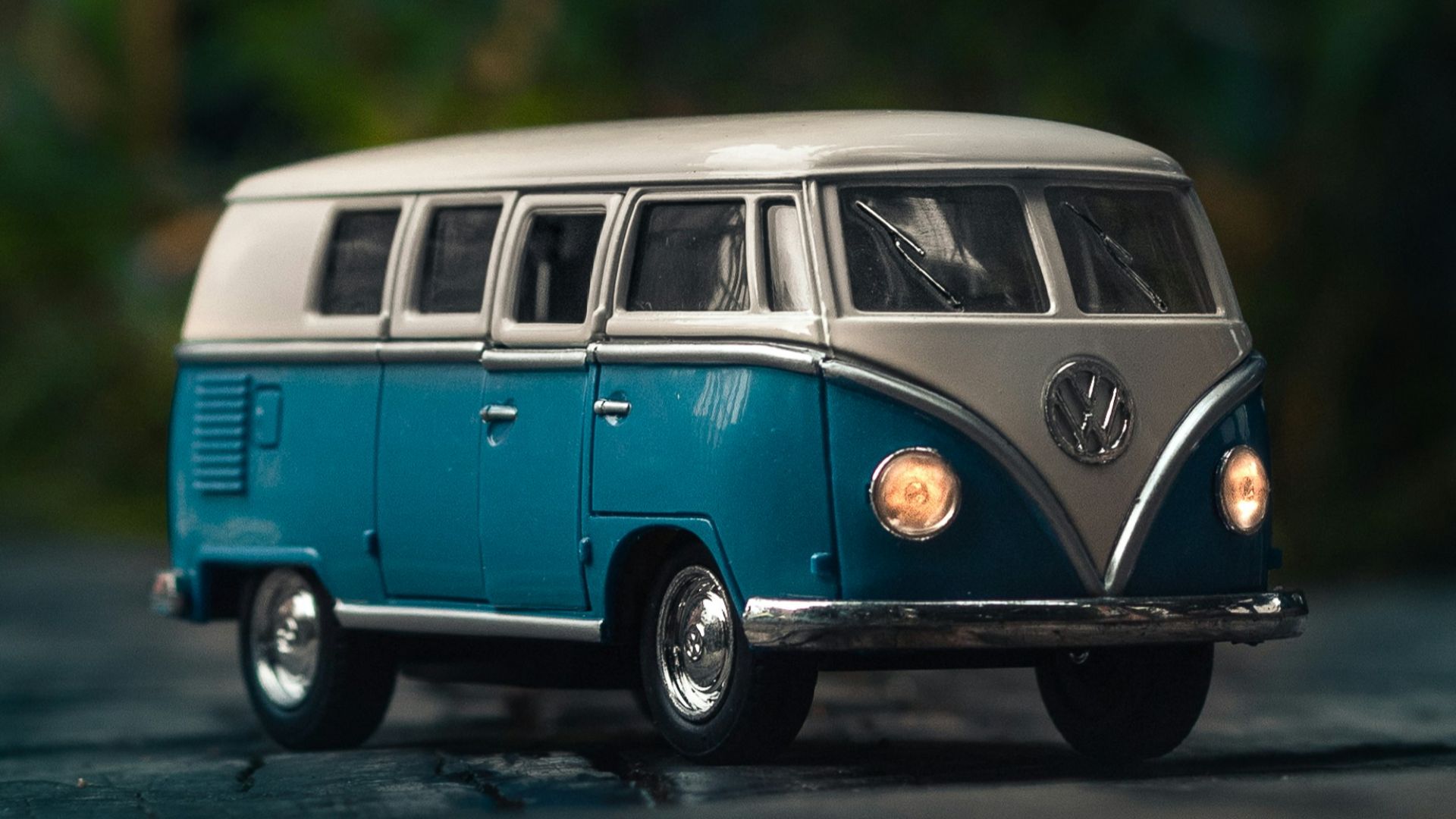 white and blue Volkswagen T1 van toy on gray surface