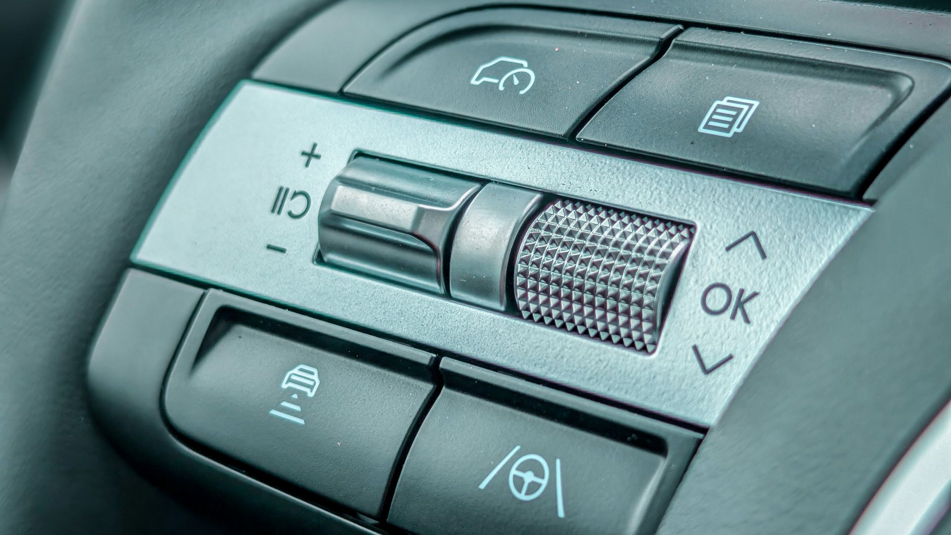 Close-up of a modern car steering wheel controls.
