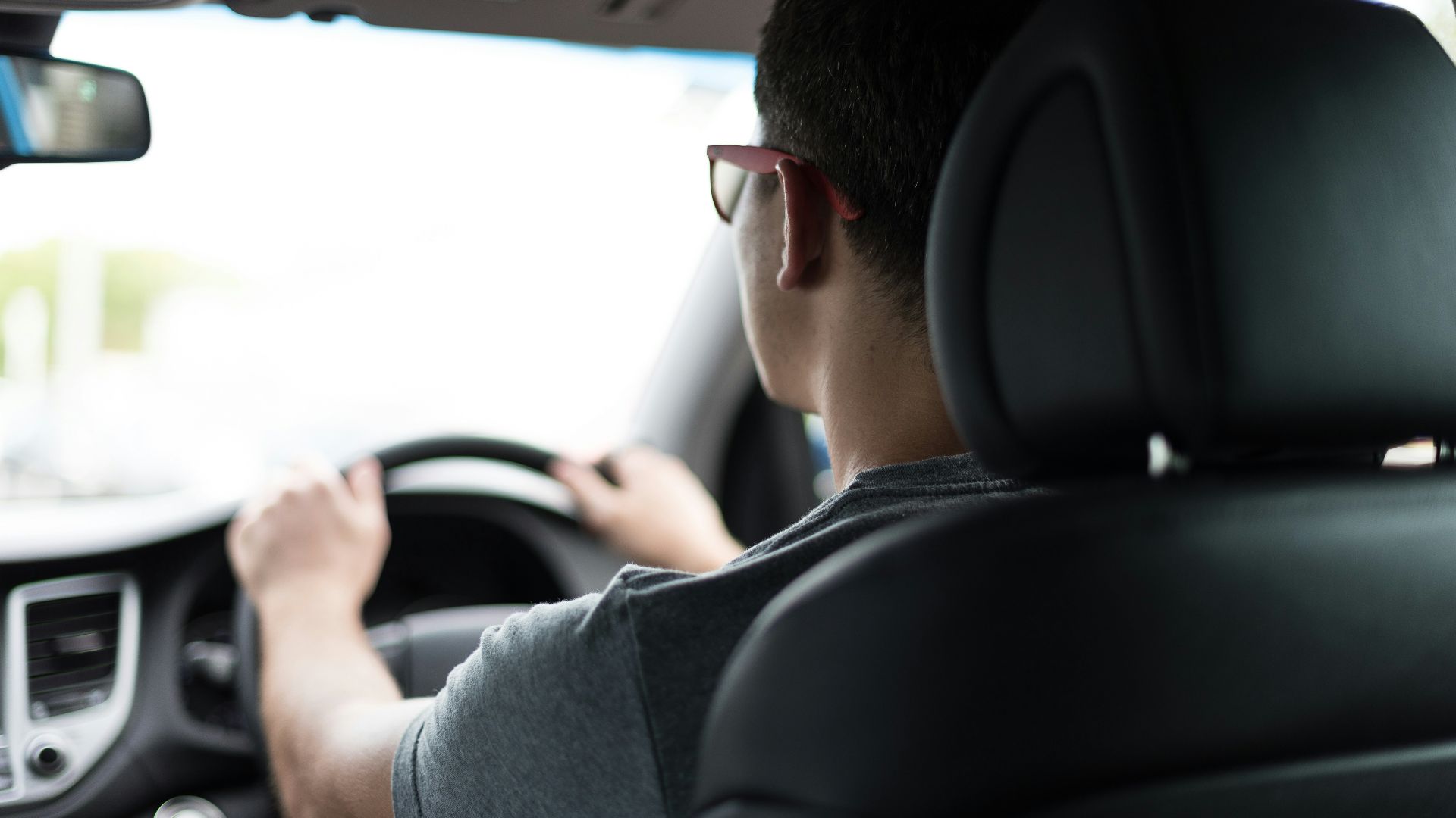 man driving car during daytime