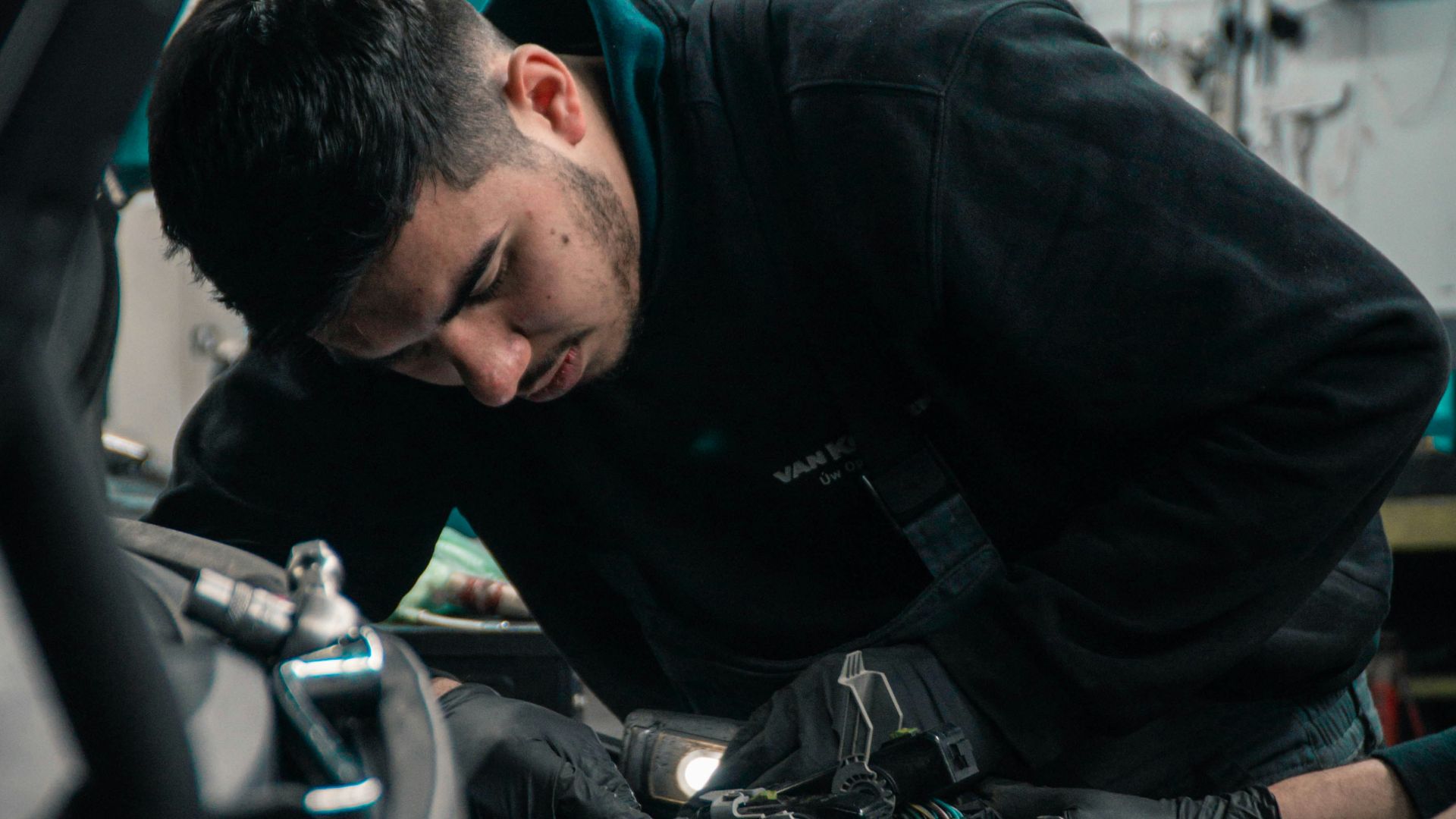 man in black jacket and blue denim jeans riding motorcycle