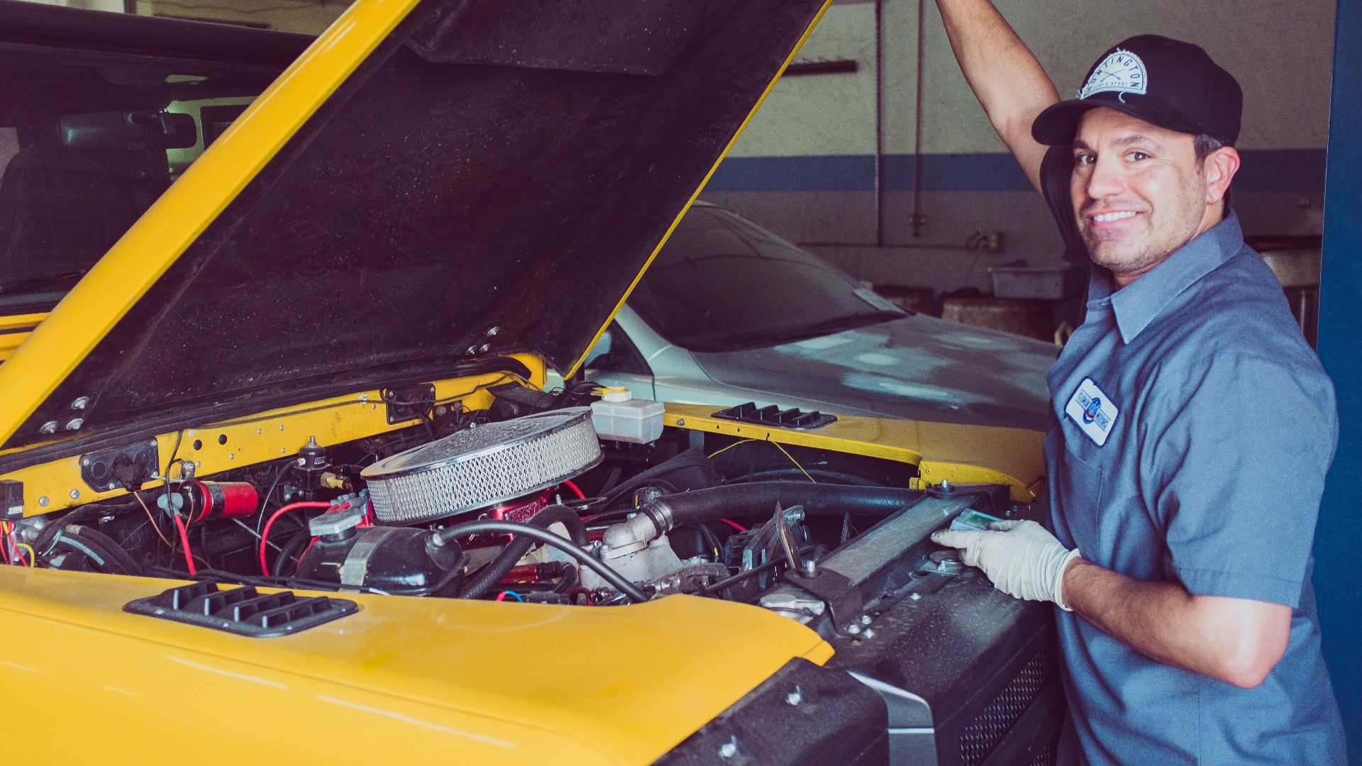 man holding open-wide car trunk