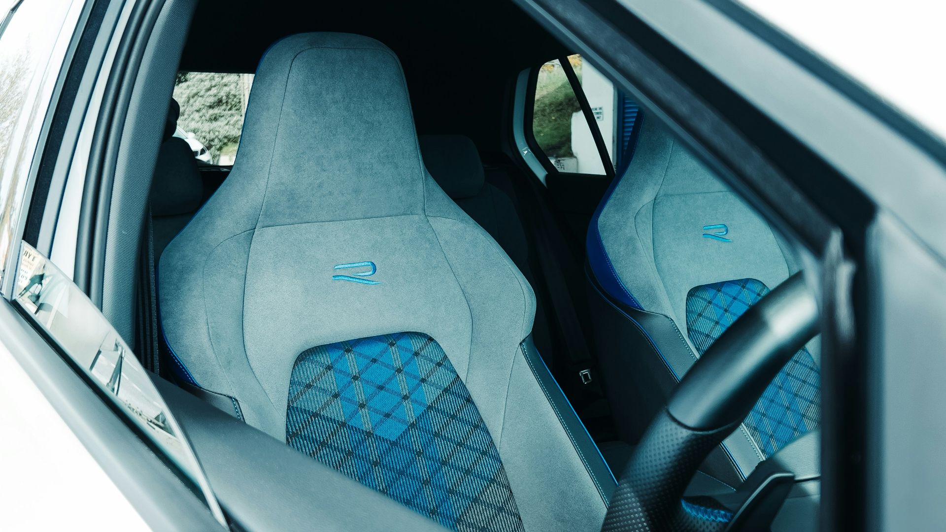 the interior of a car with blue seats