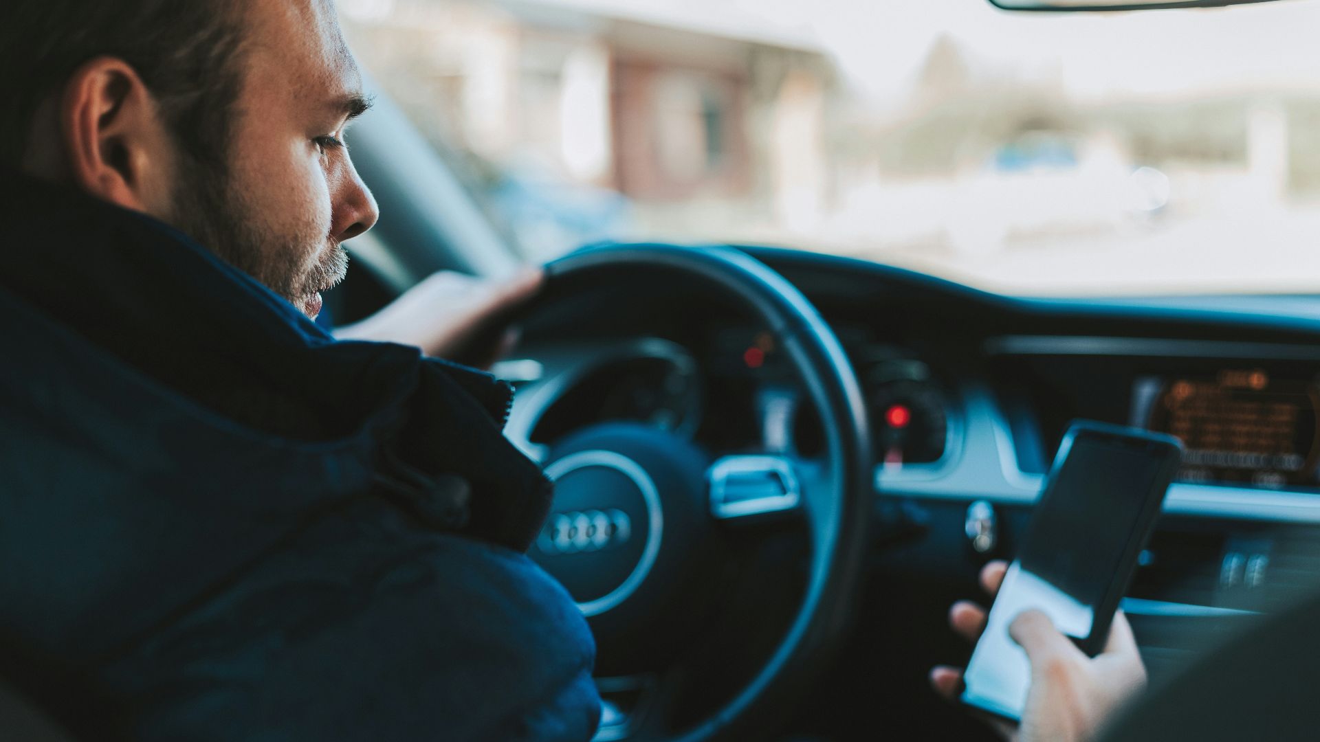 man holding black smartphone