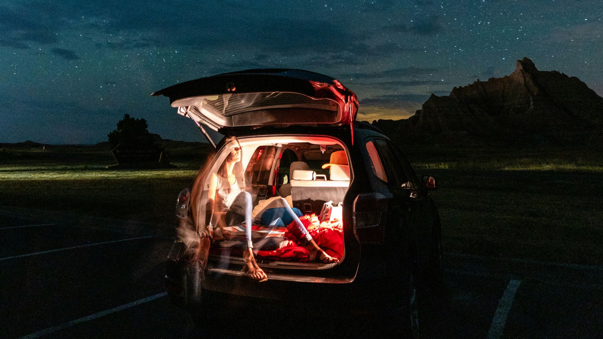 man in black jacket driving car during night time