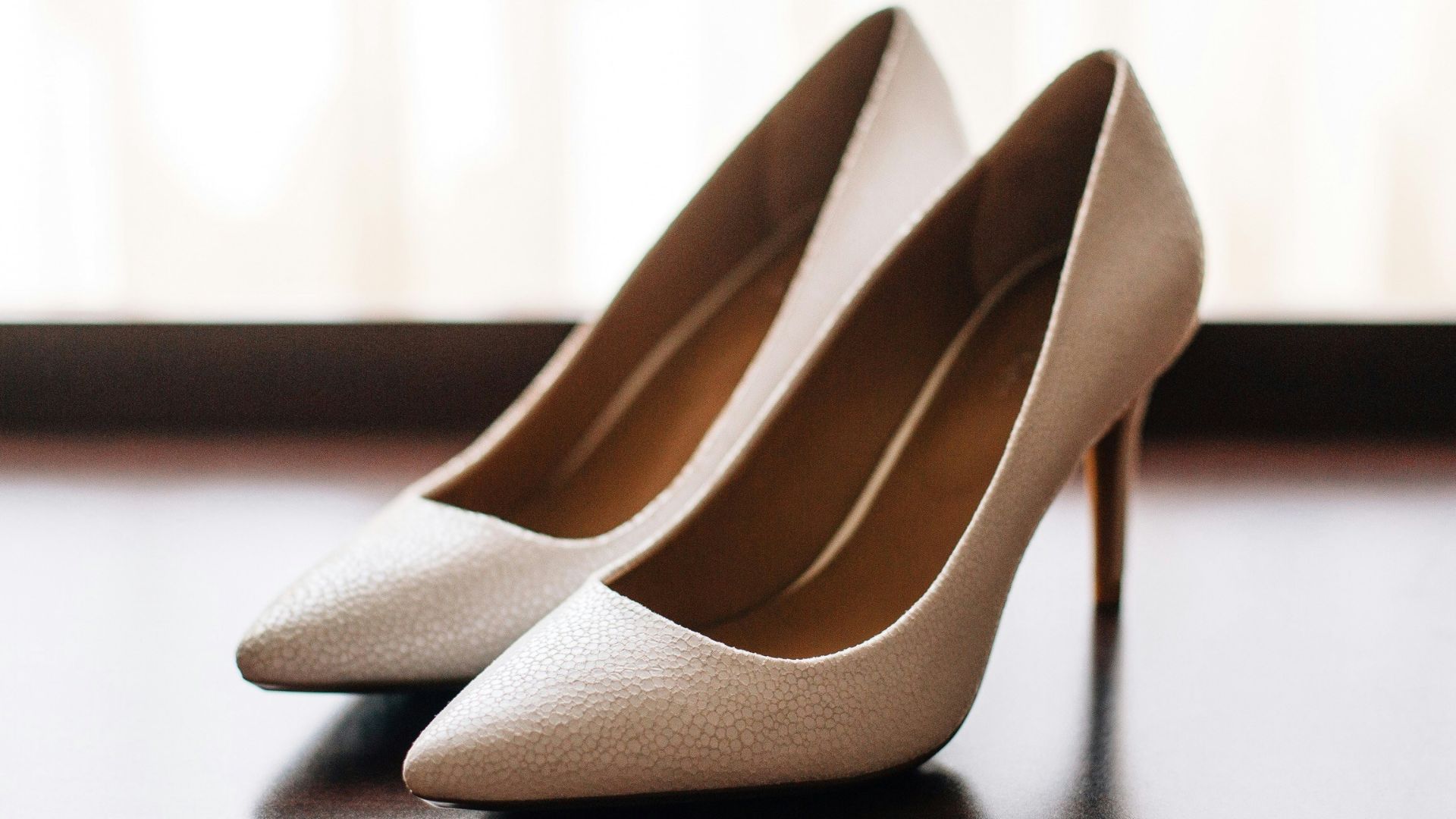 pair of women's brown pointed-toe pumps on board