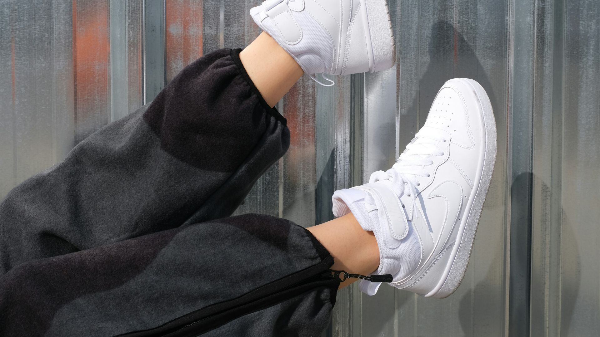 person wearing white nike sneakers