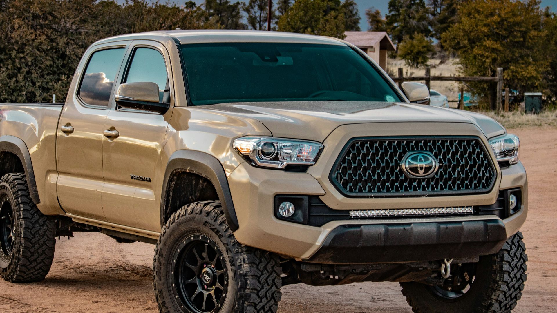 white Toyota crew cab pickup truck on ground