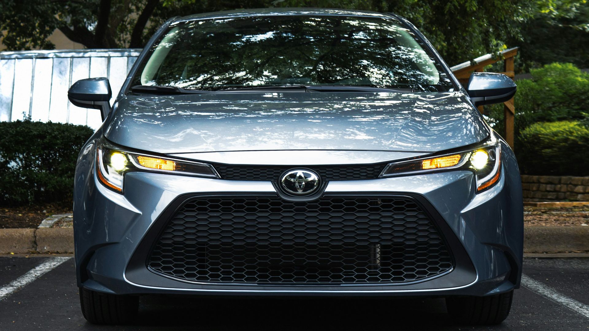 black mercedes benz car parked near green trees during daytime
