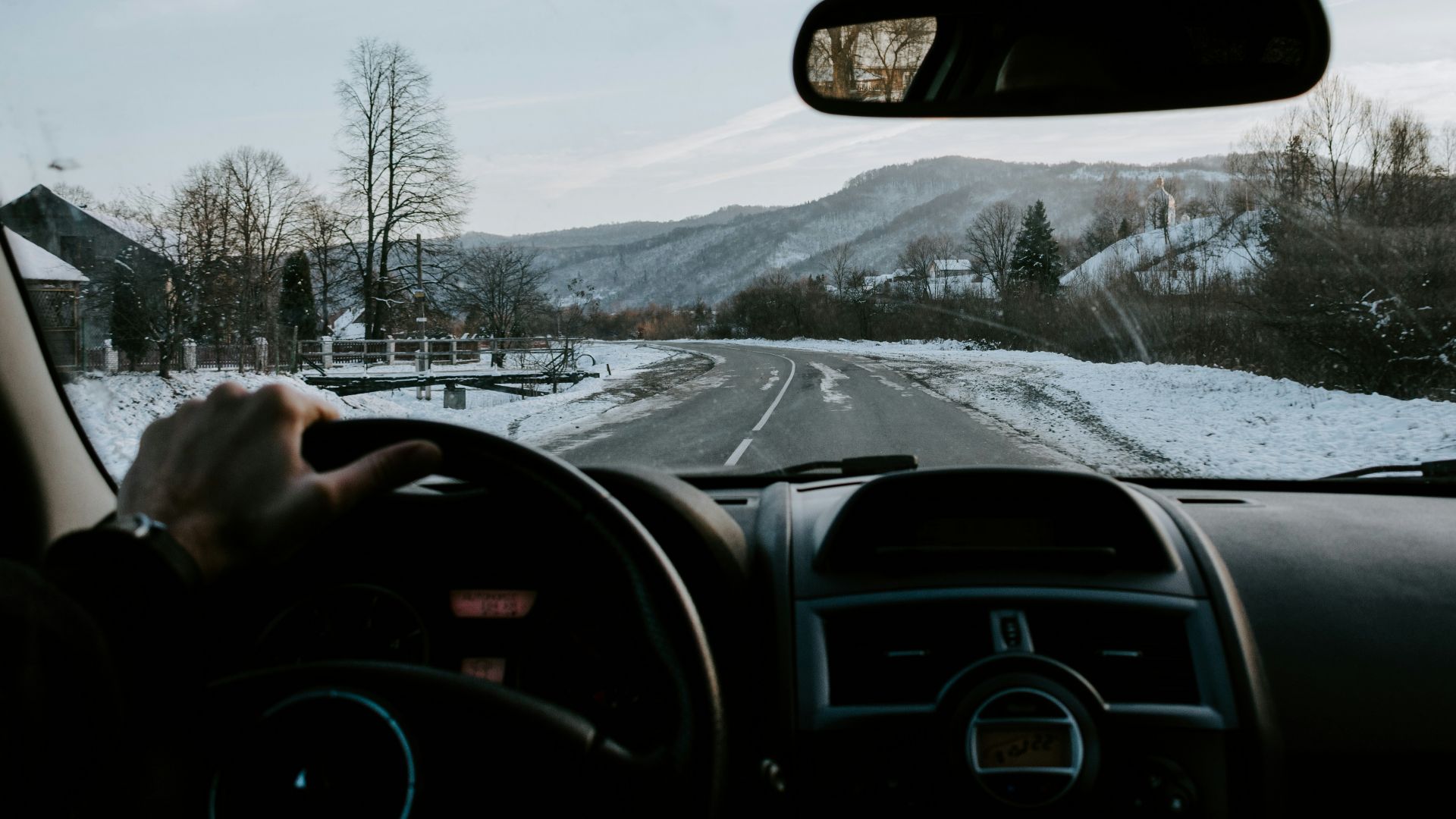 person holding steering wheel