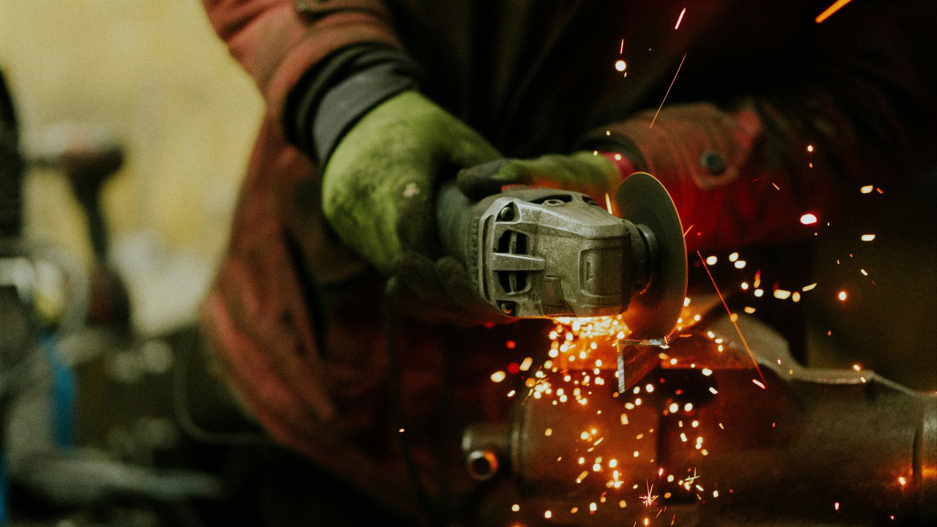 a person using a grinder on a piece of metal