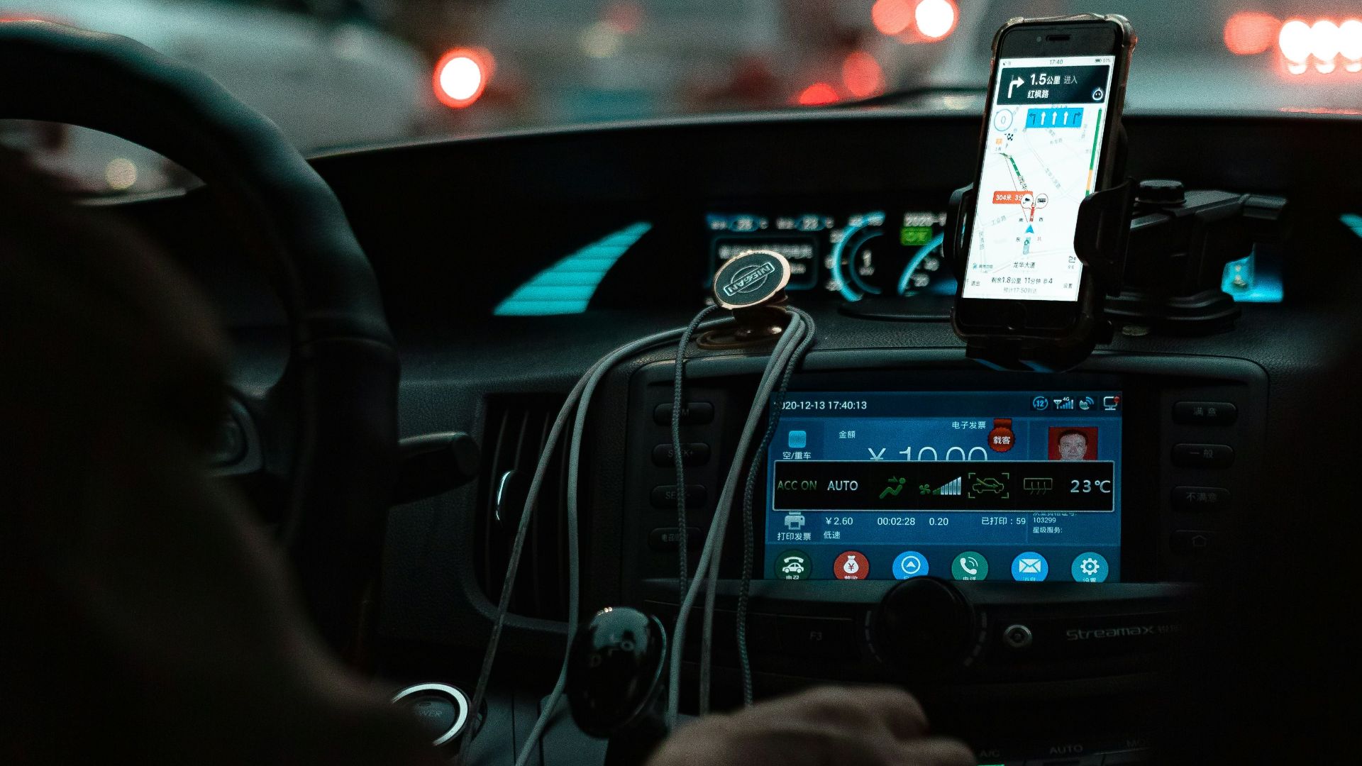 person holding iphone 6 taking photo of cars on road during night time