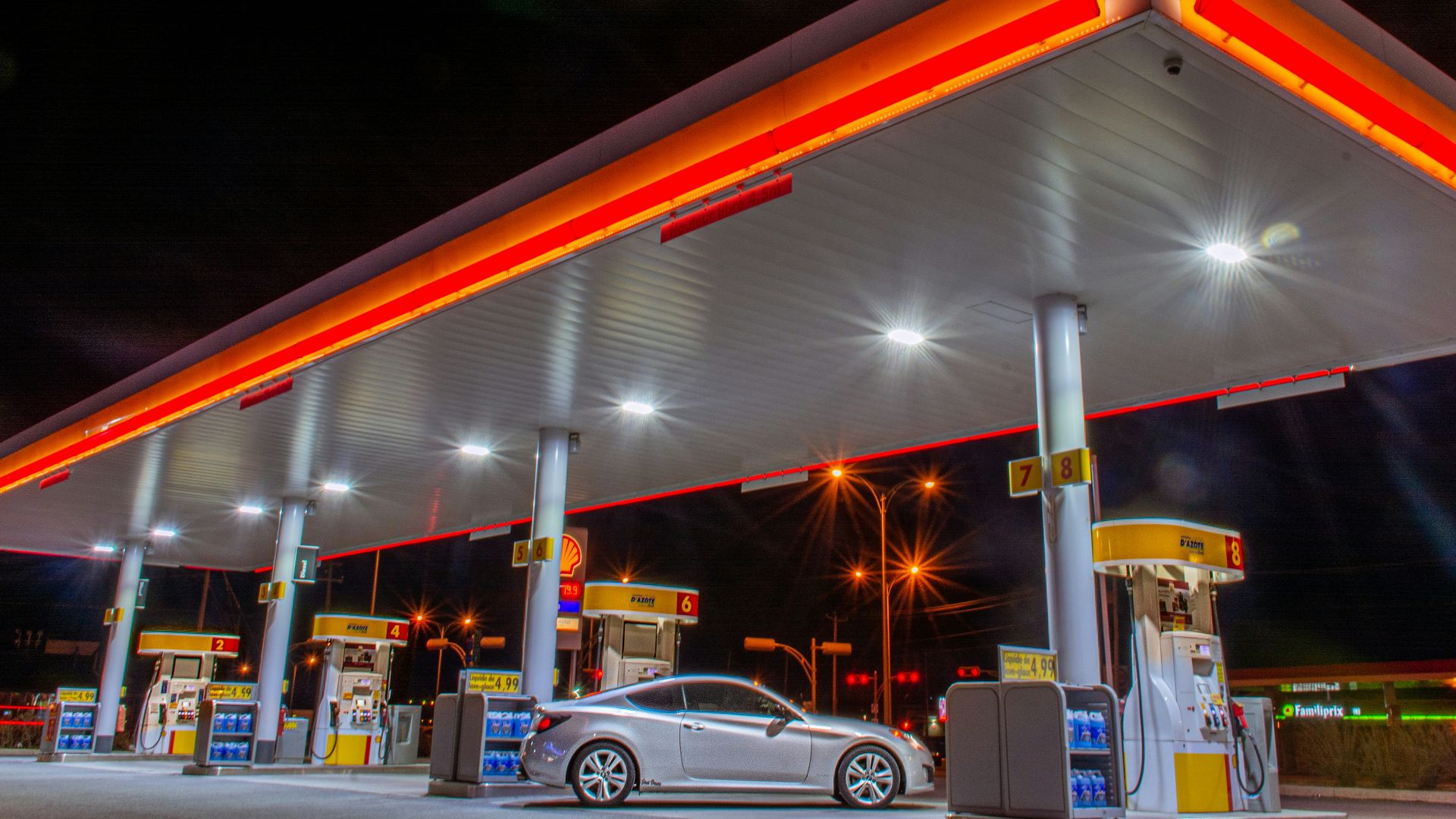 white car parked in front of red and white building during night time
