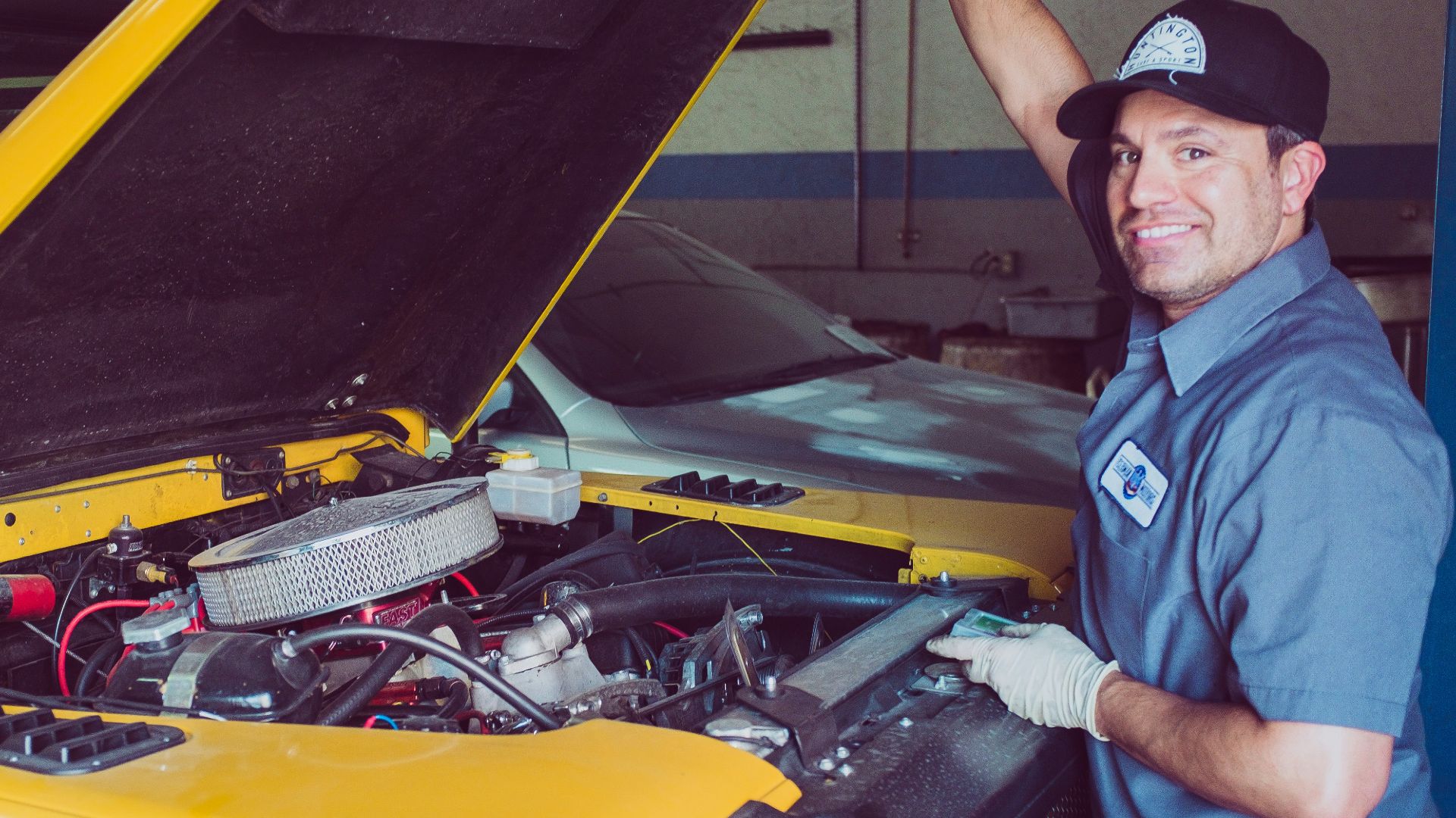 man holding open-wide car trunk