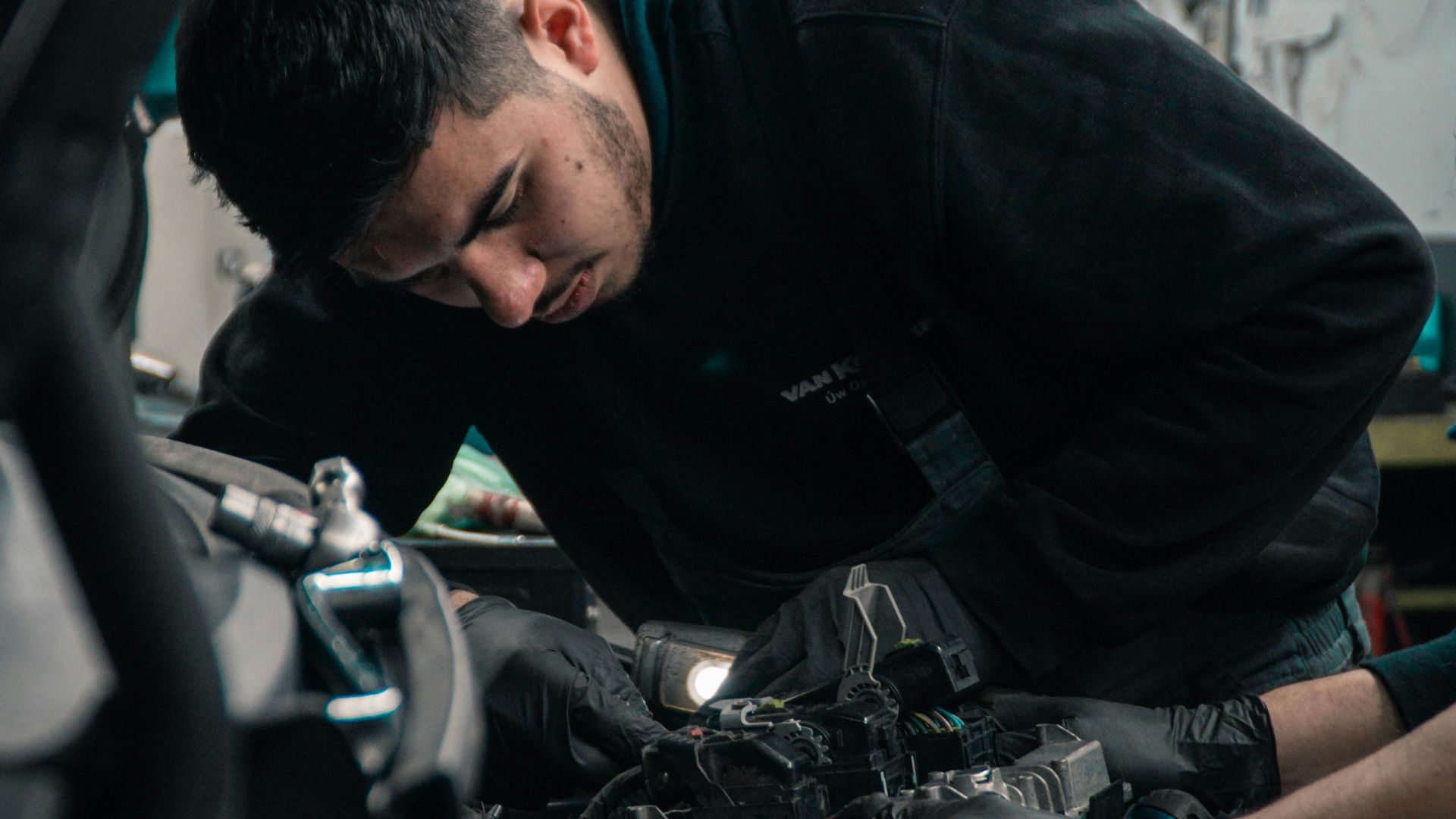 man in black jacket and blue denim jeans riding motorcycle