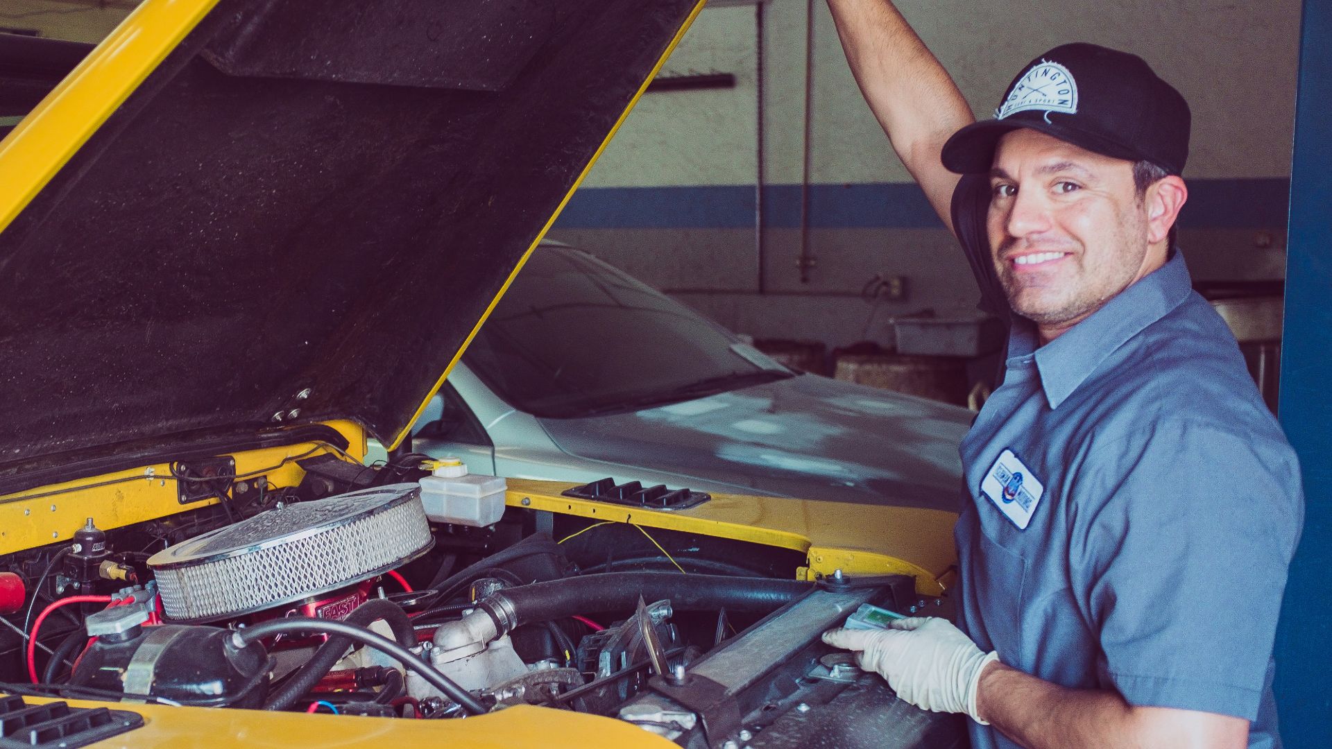 man holding open-wide car trunk