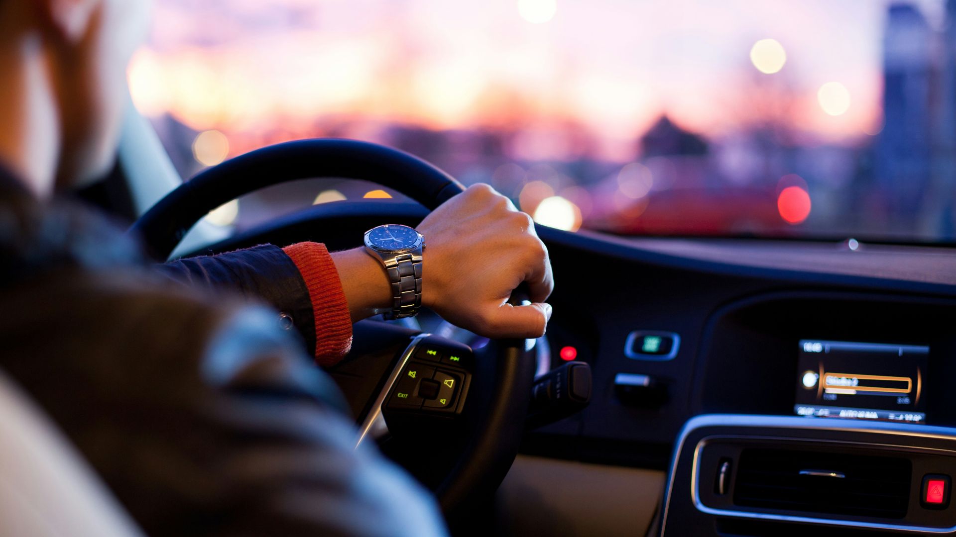 man driving a car wearing wrist watch