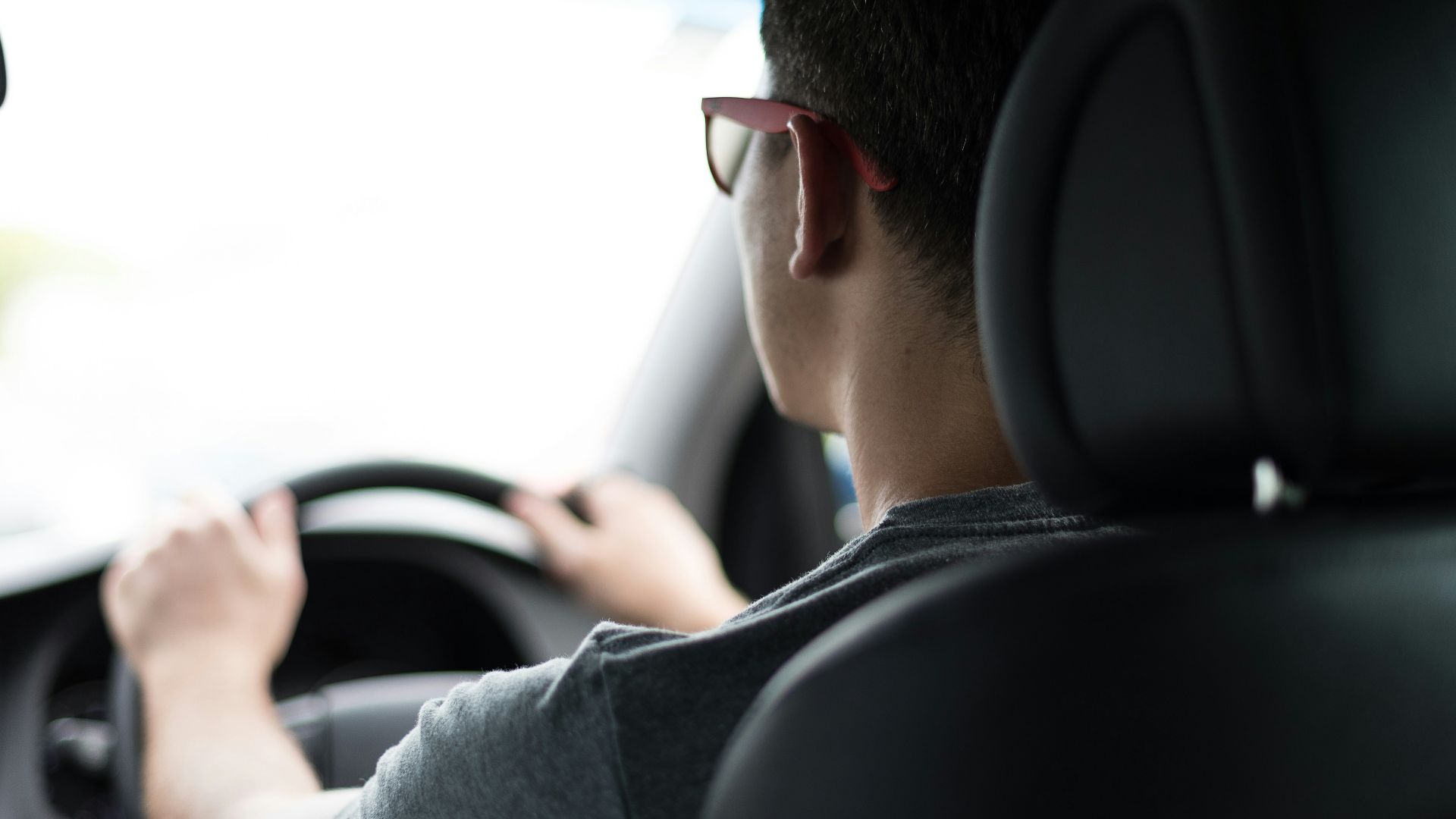 man driving car during daytime