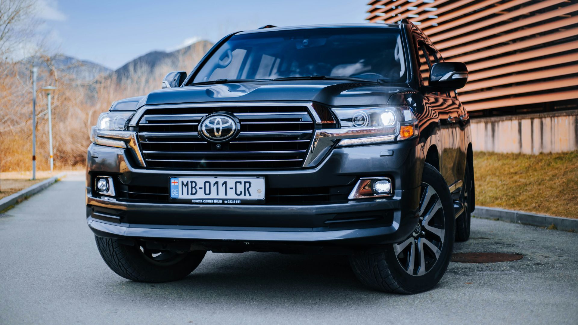 a black toyota land cruiser parked in front of a building