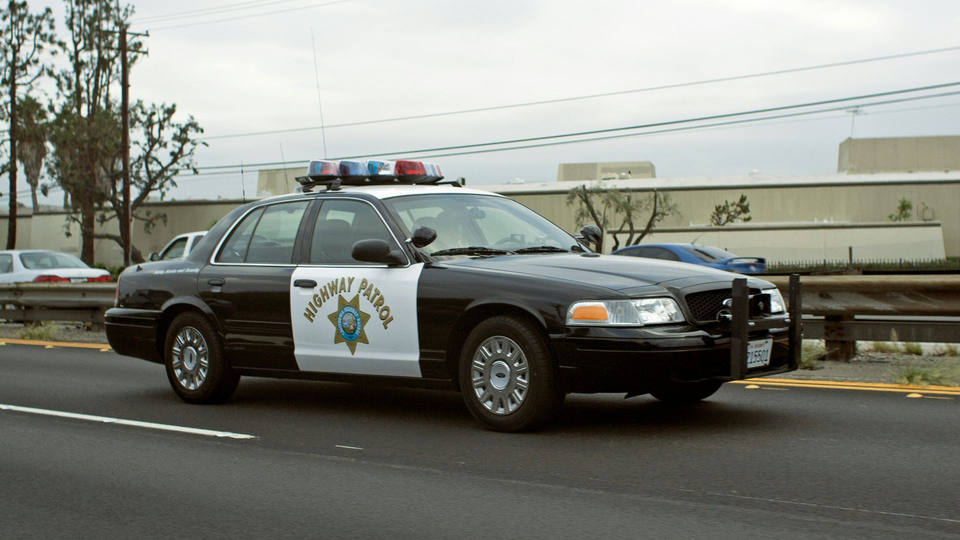 A california highway patrol car drives down the road.