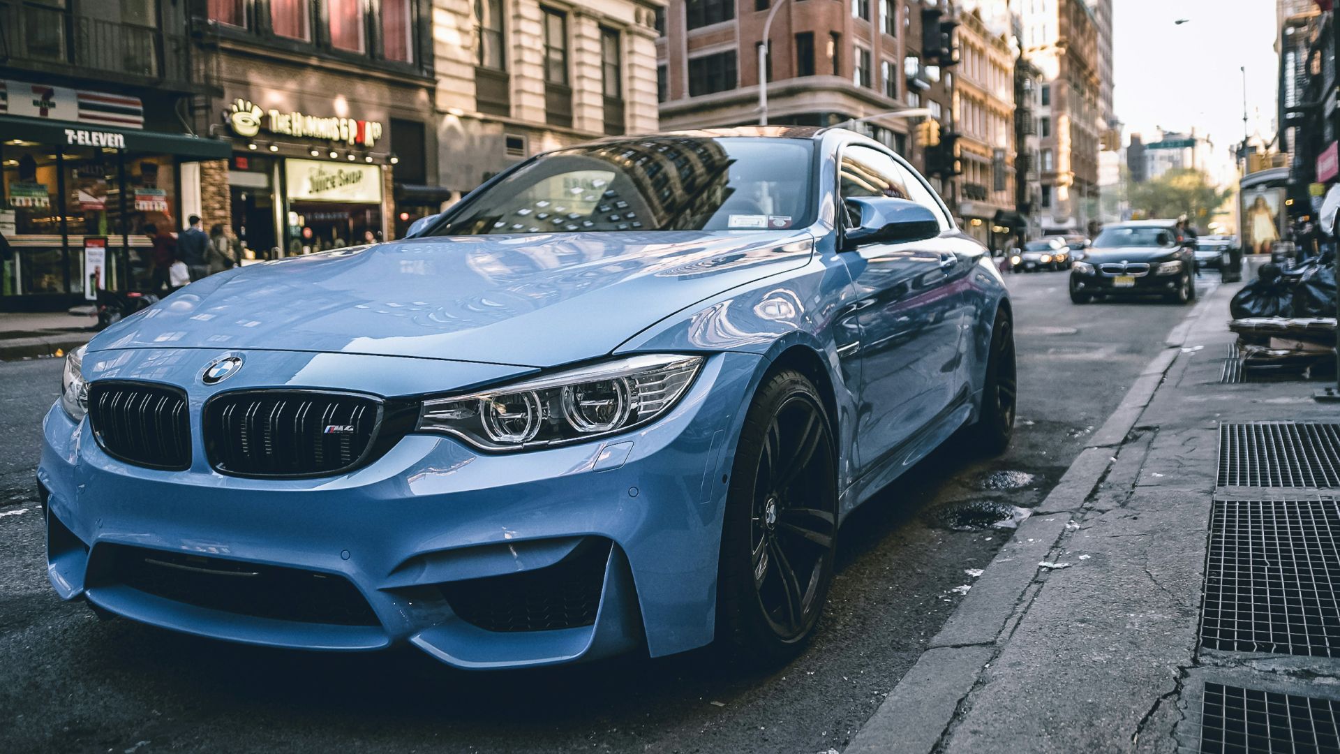 blue BMW coupe parked on the road during daytime