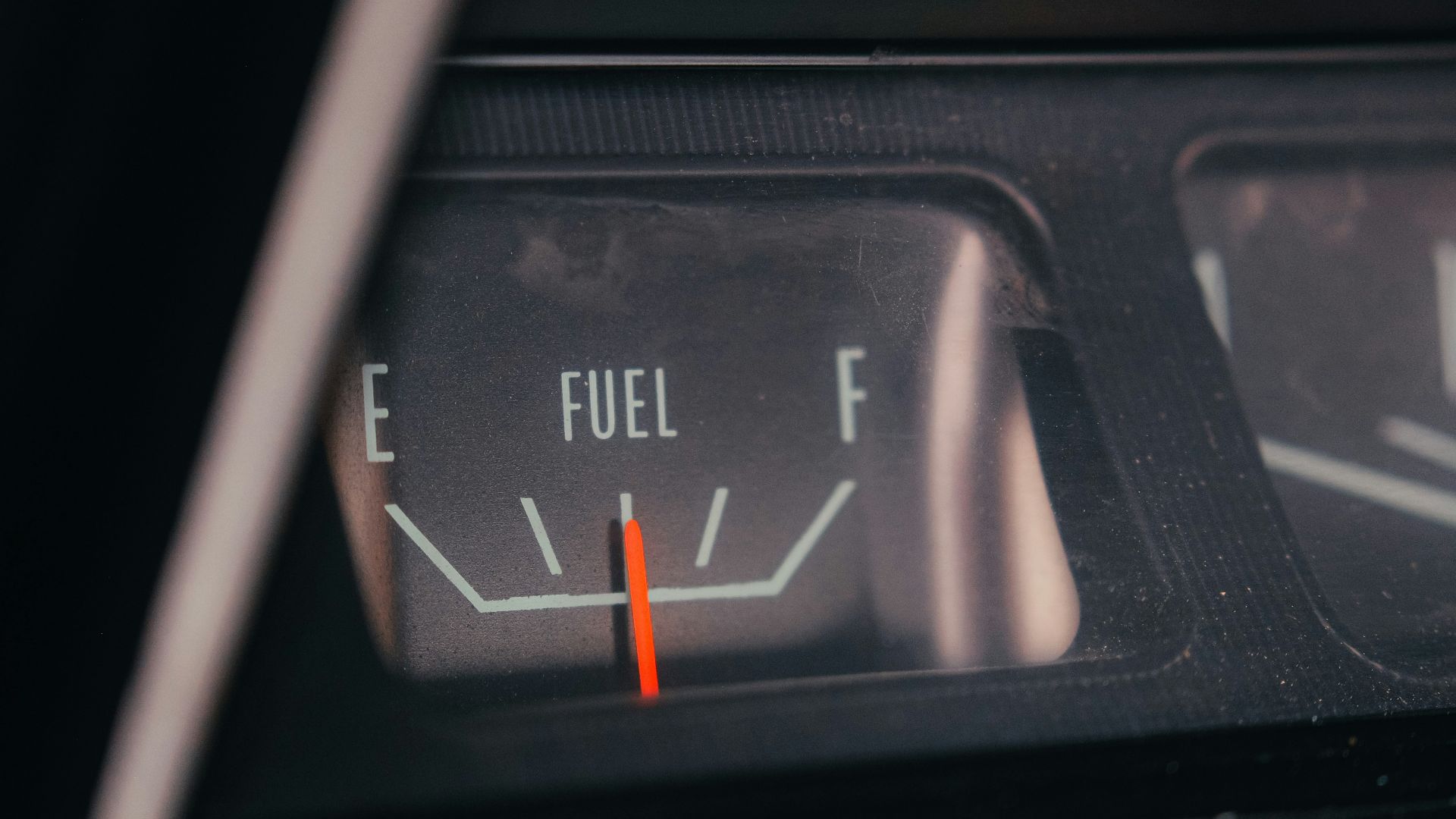 Close-up of a car's fuel gauge showing empty
