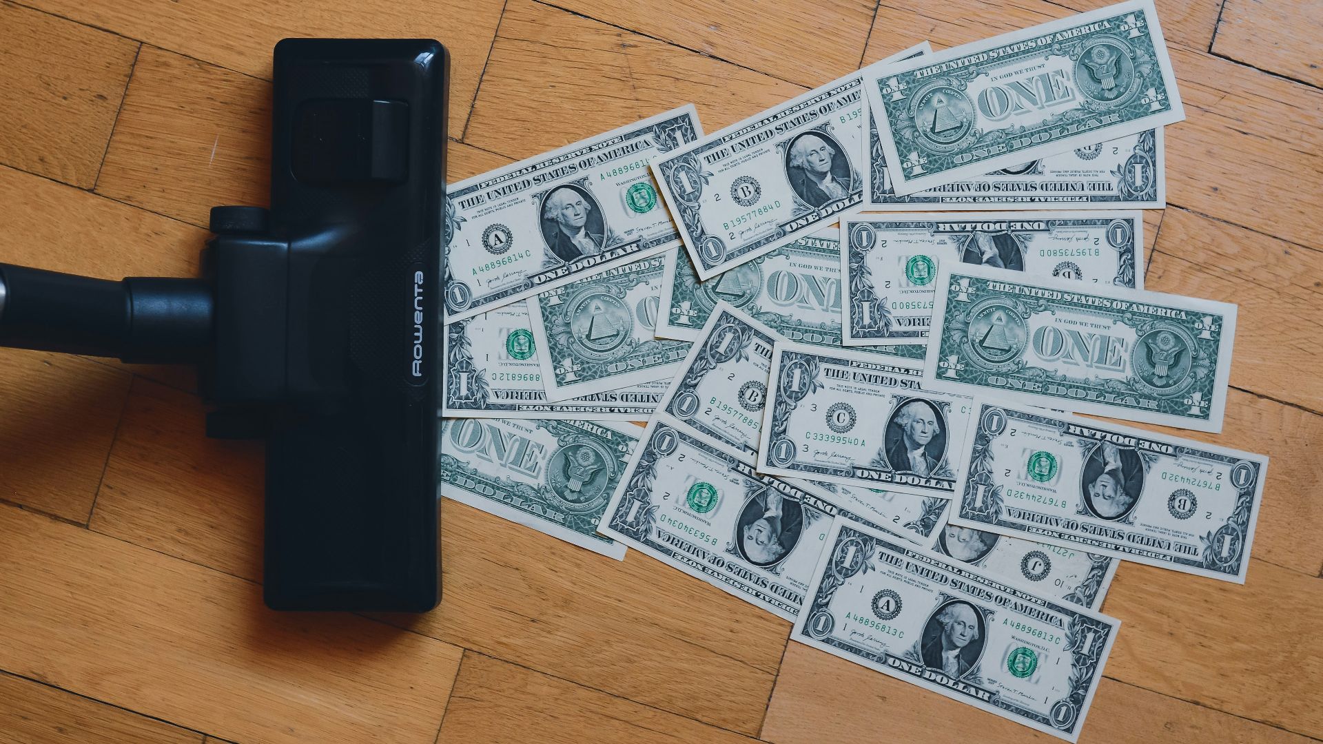a pile of money sitting on top of a wooden floor