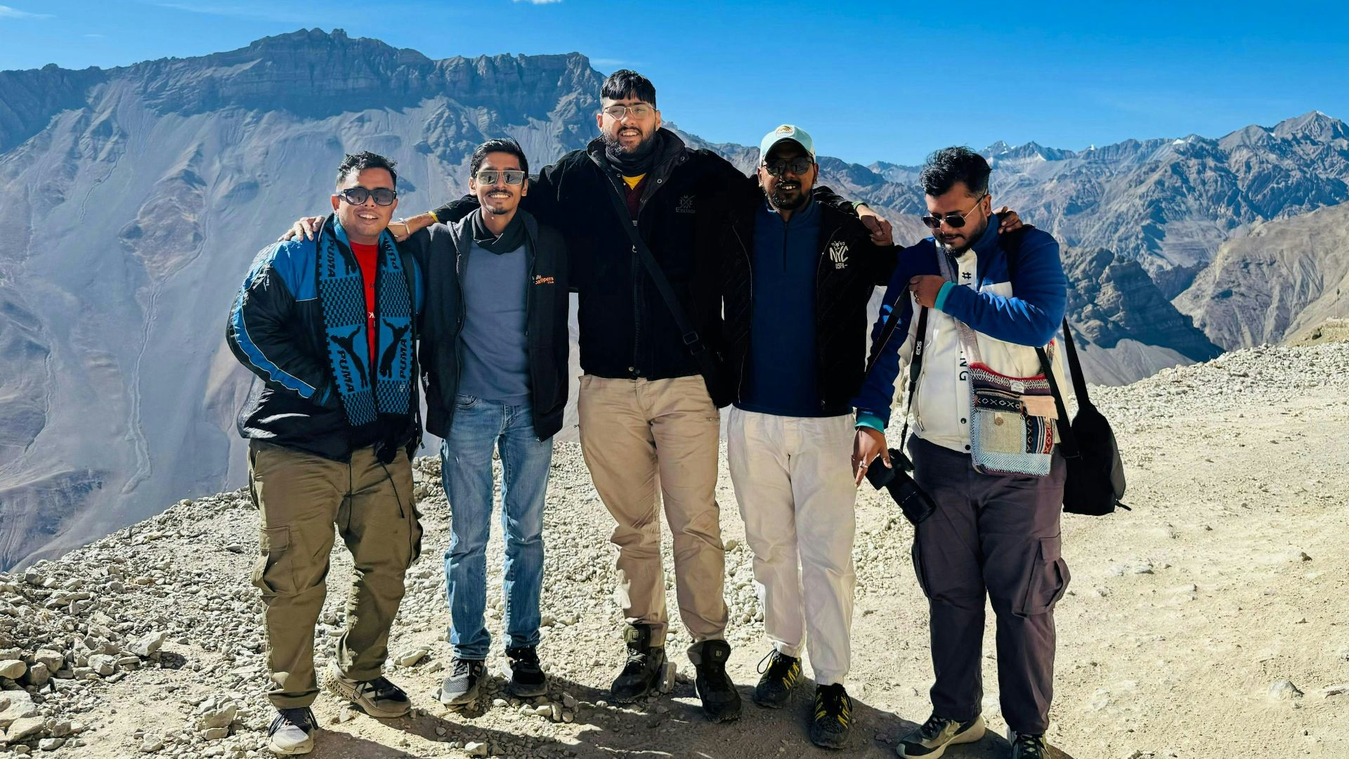 A group of men standing on top of a mountain