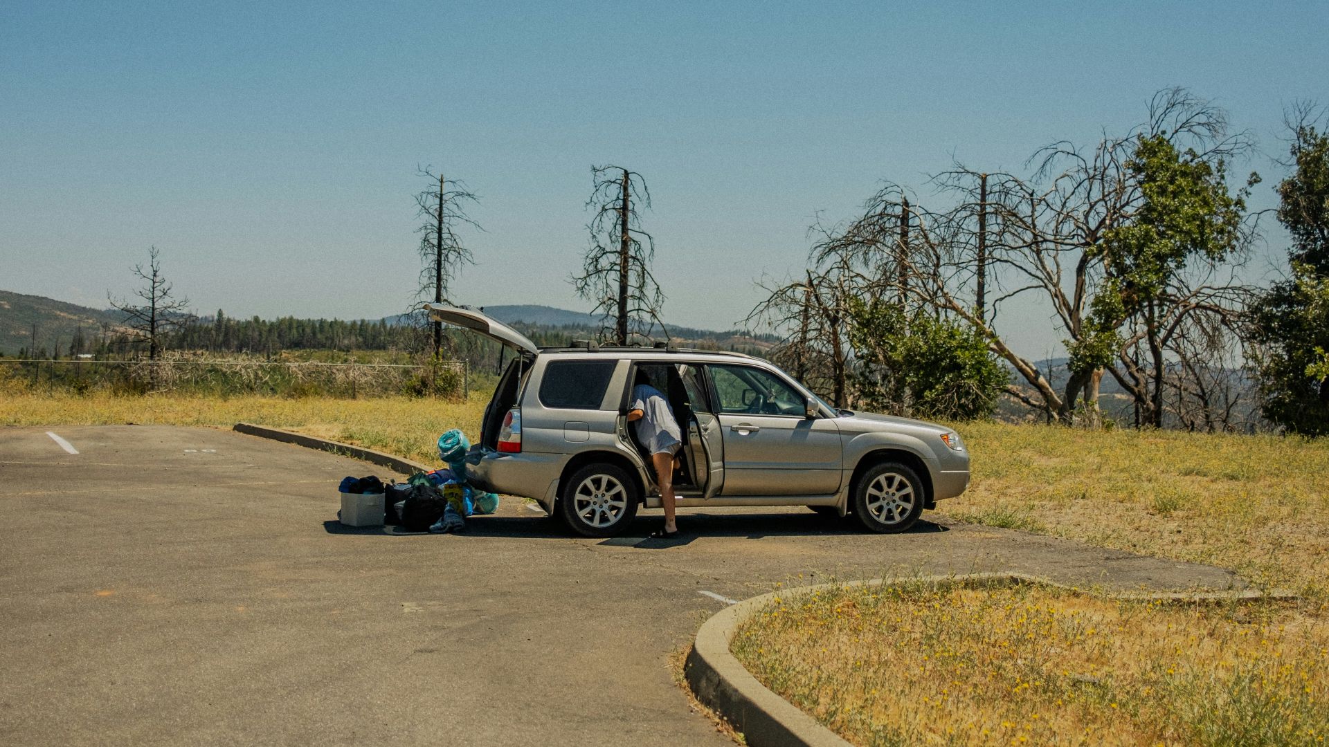 a person standing next to a car