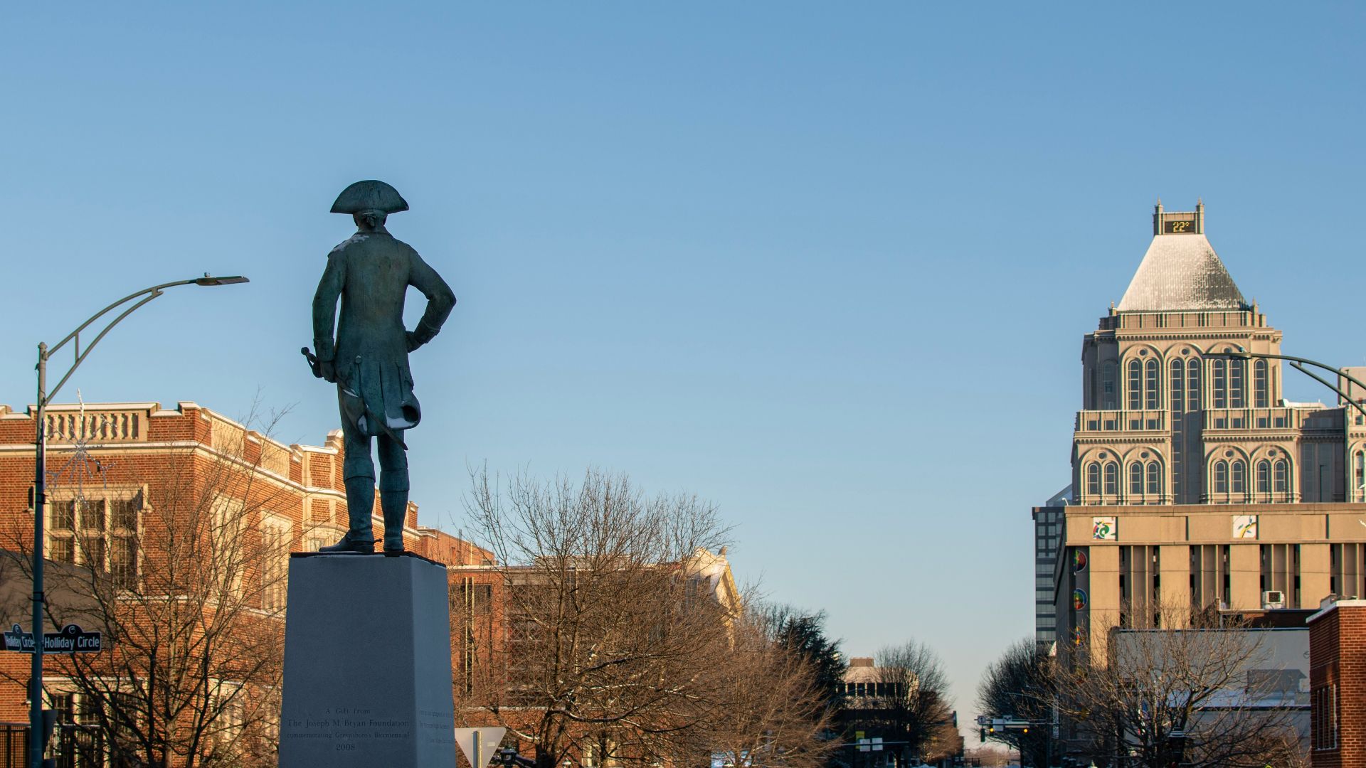 a statue of a man standing in the middle of a street