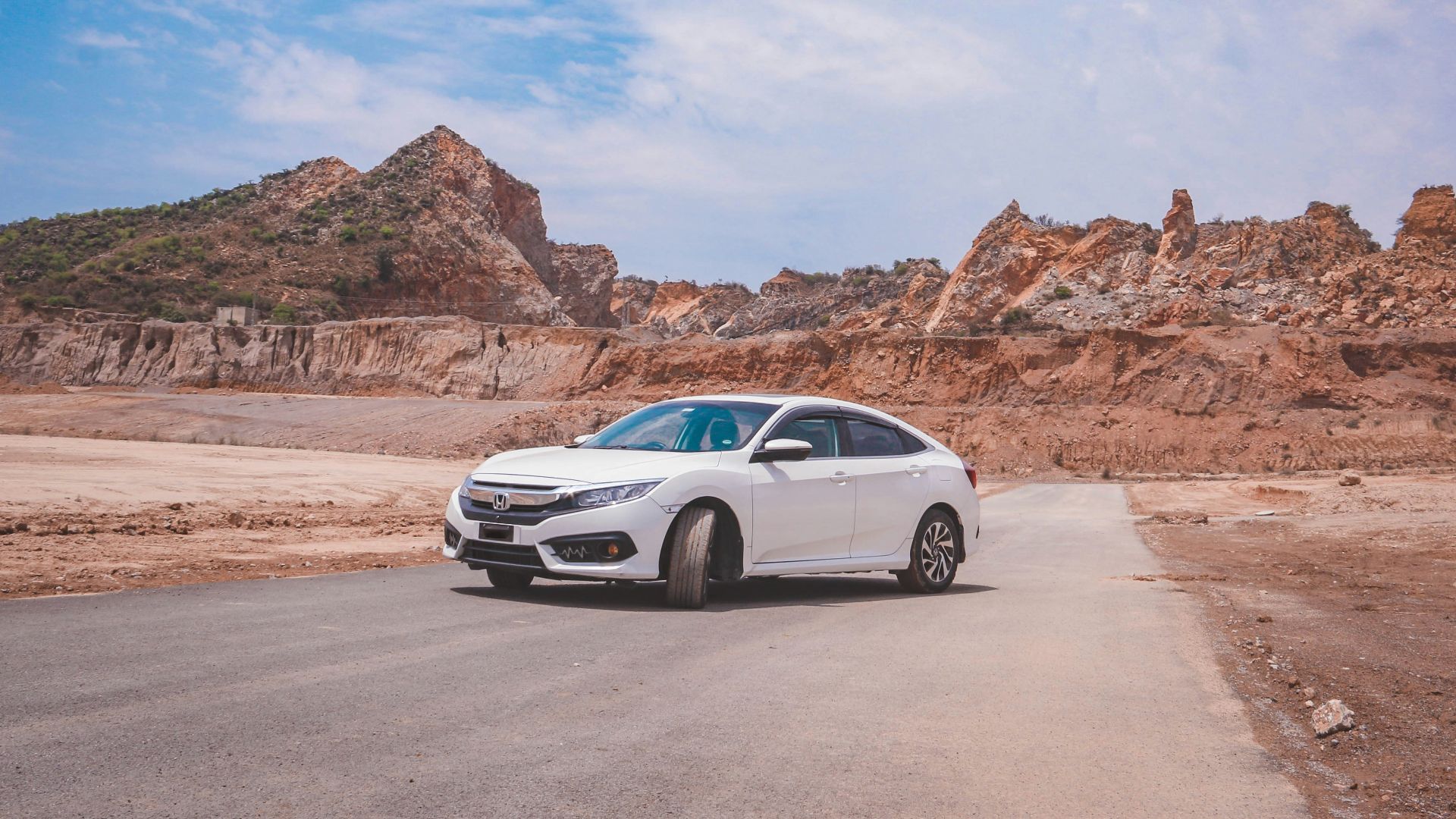 a white car parked on the side of a road