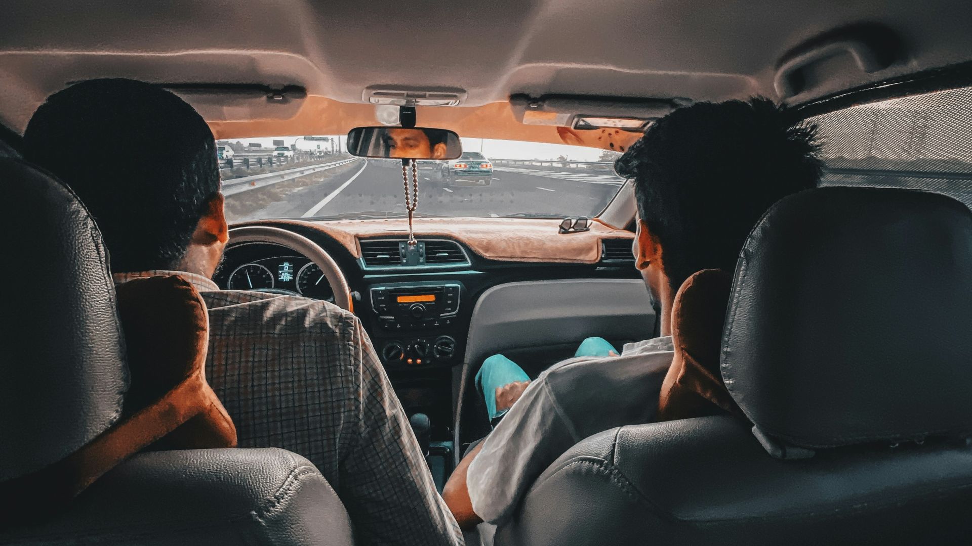 man in black shirt driving car