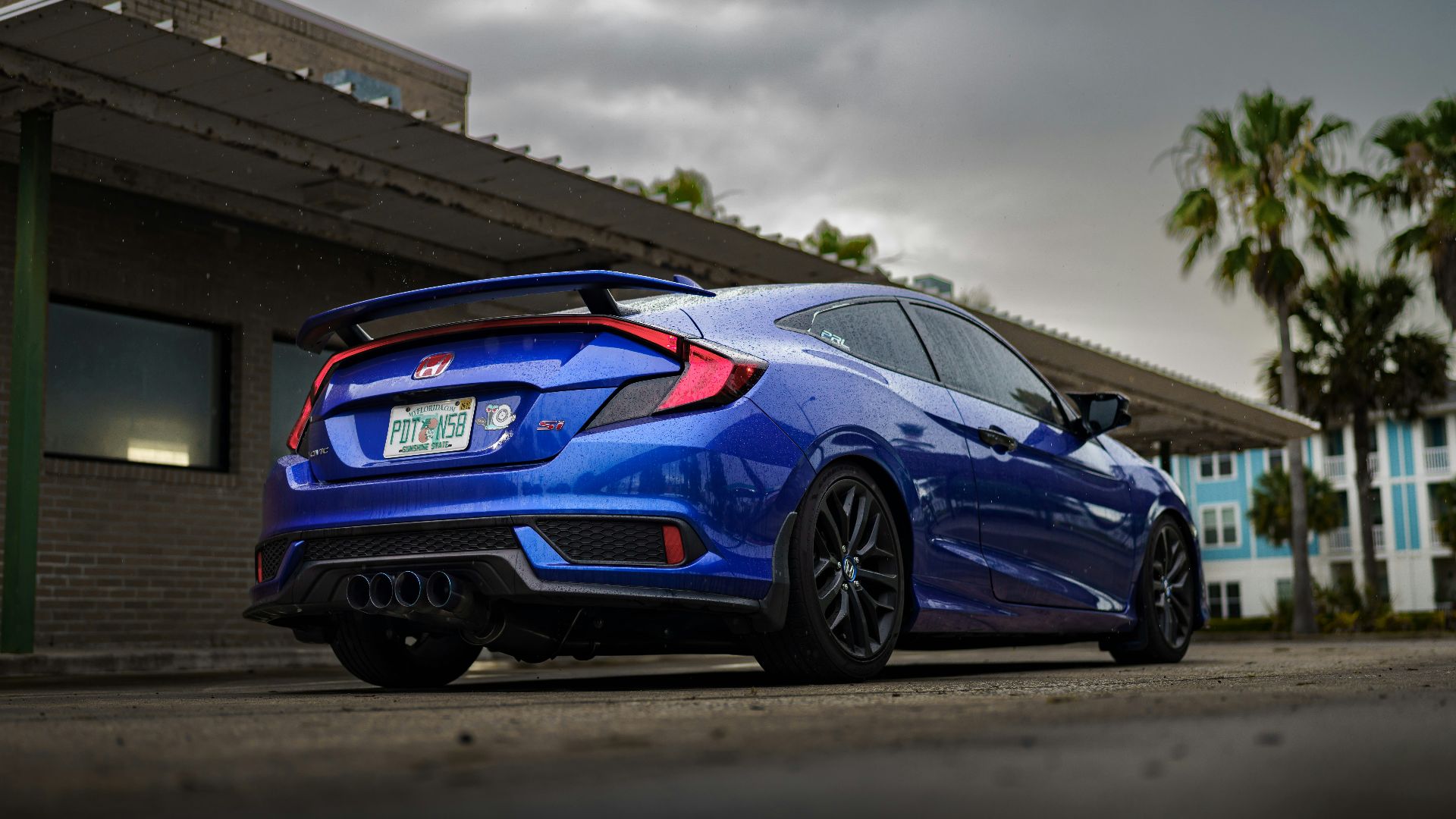 a blue car parked outside a building