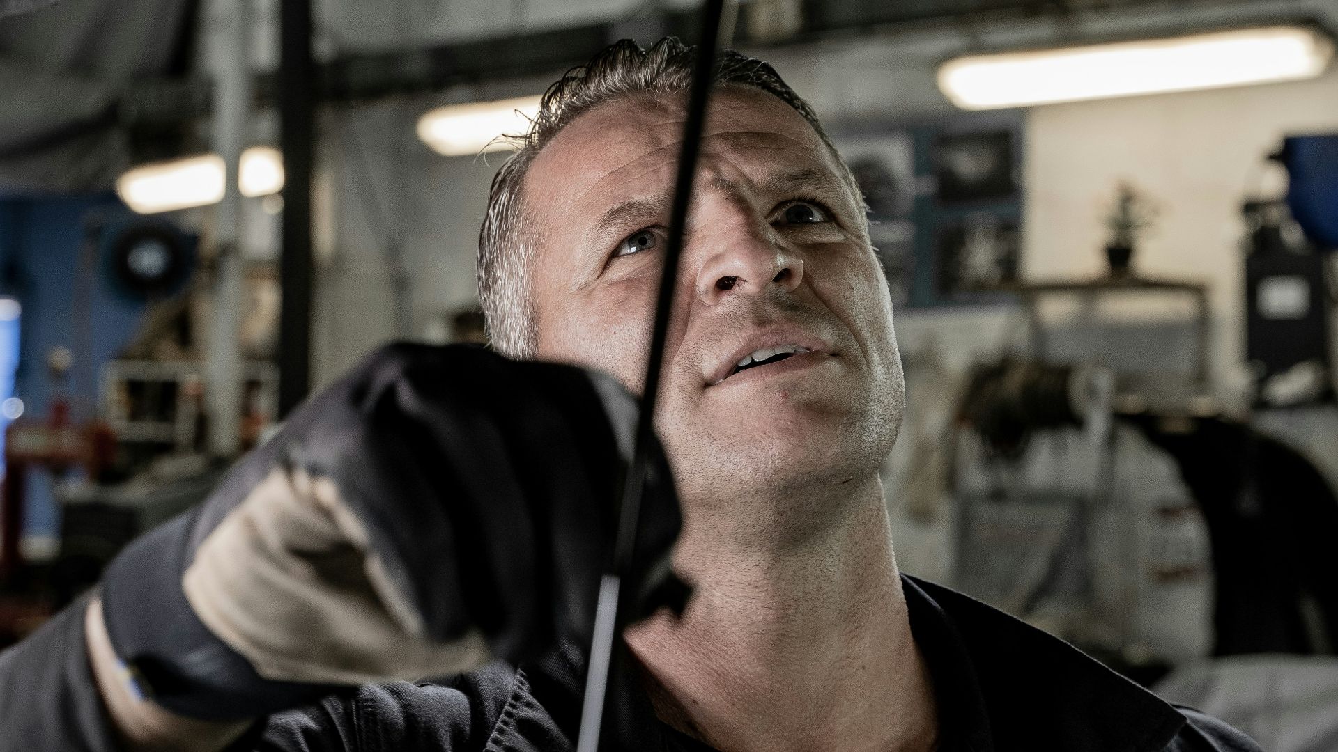 a man working on a car in a garage