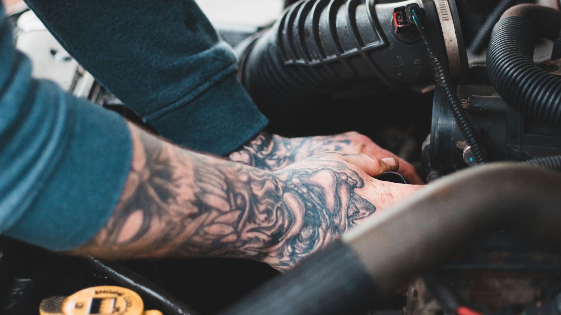 person in blue denim jeans and black and white adidas sneakers riding on black motorcycle