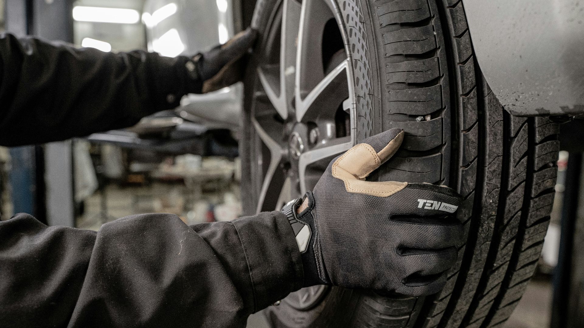 a man working on a tire in a garage