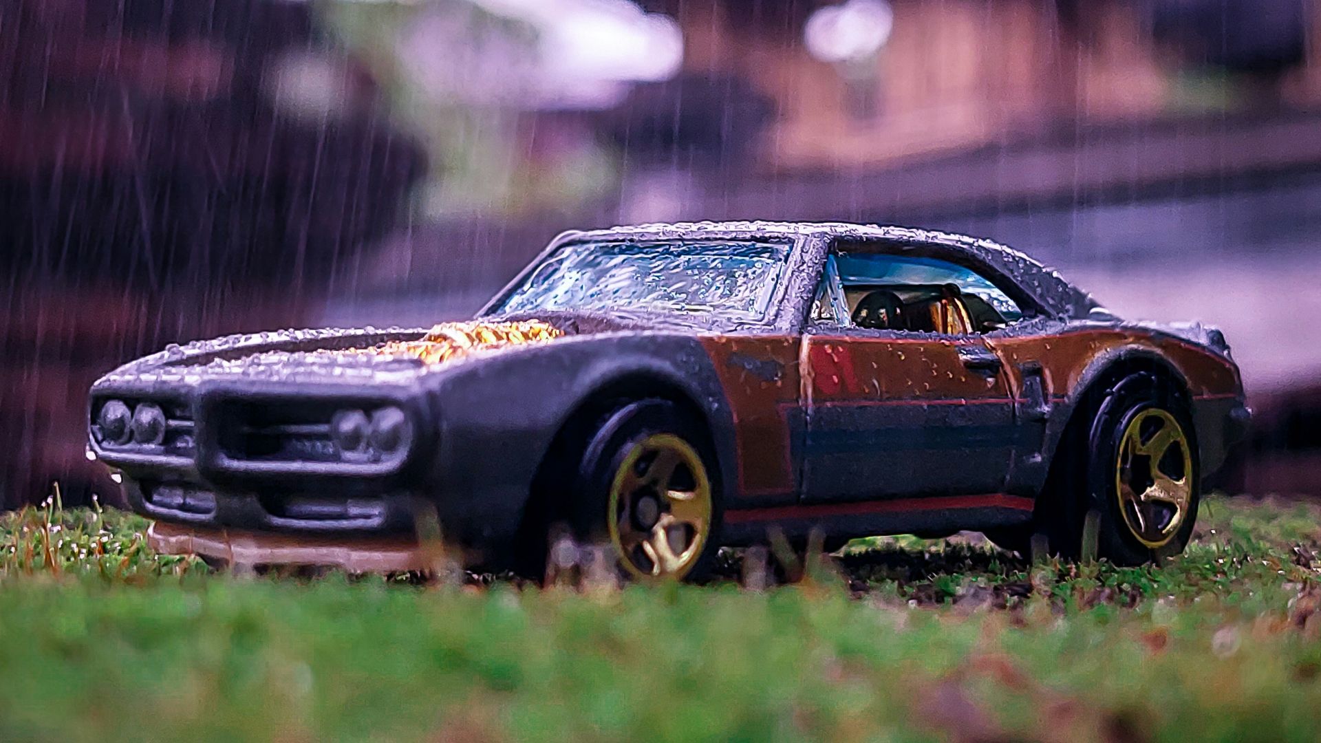 a toy car sitting on top of a lush green field