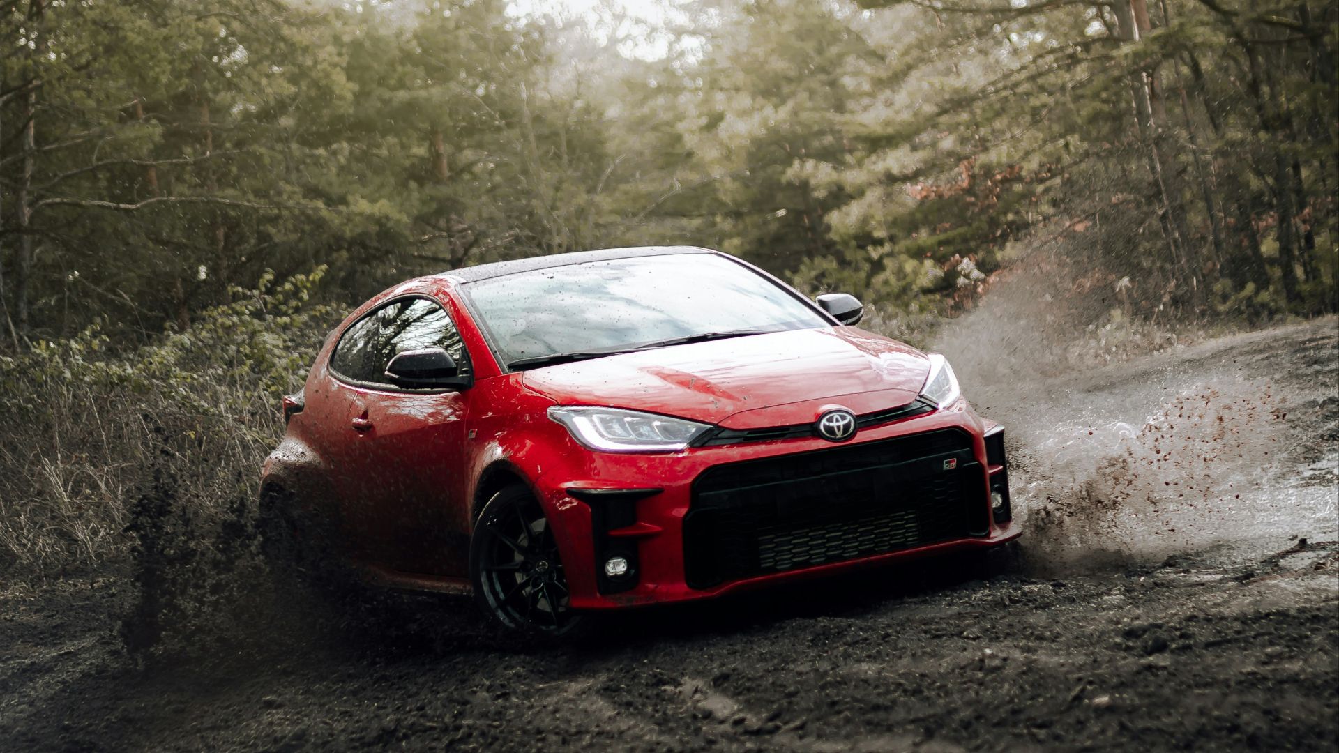 red chevrolet camaro on road