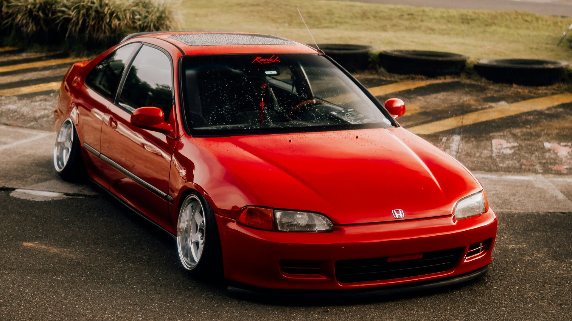 a red car parked in a parking lot