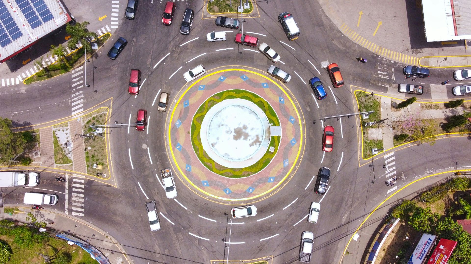an aerial view of a city intersection with cars