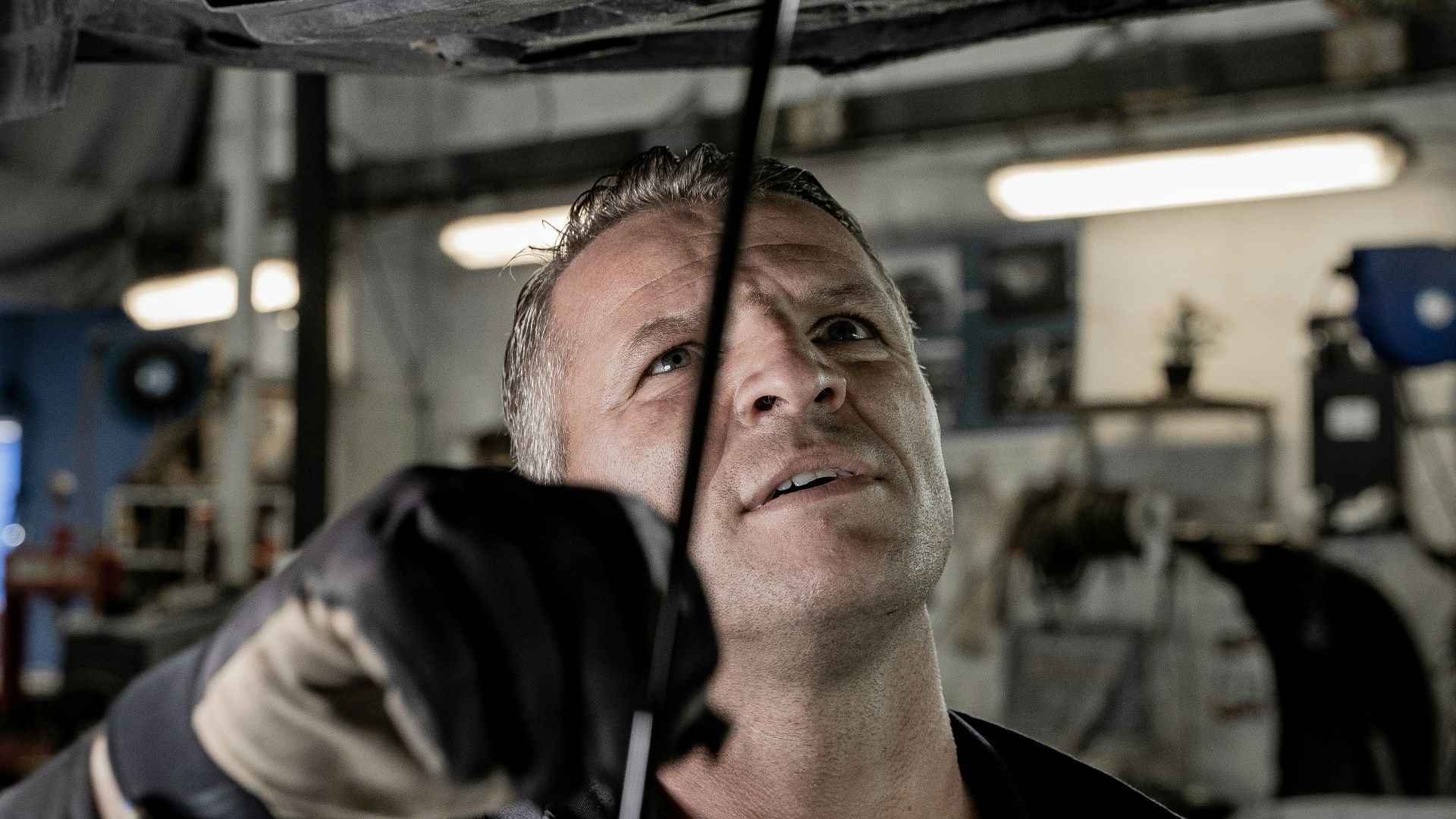 a man working on a car in a garage