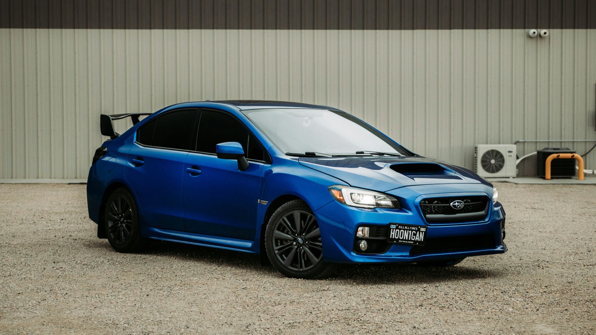 blue bmw m 3 coupe parked near gray roll up door